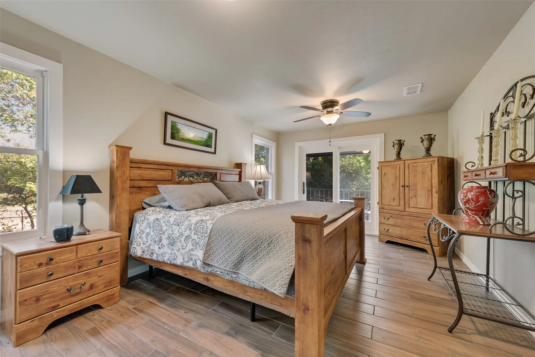 Wood-finish flooring, ceiling fan with integrated lighting, recessed lighting, double-pane windows, and a glass-paneled exterior door