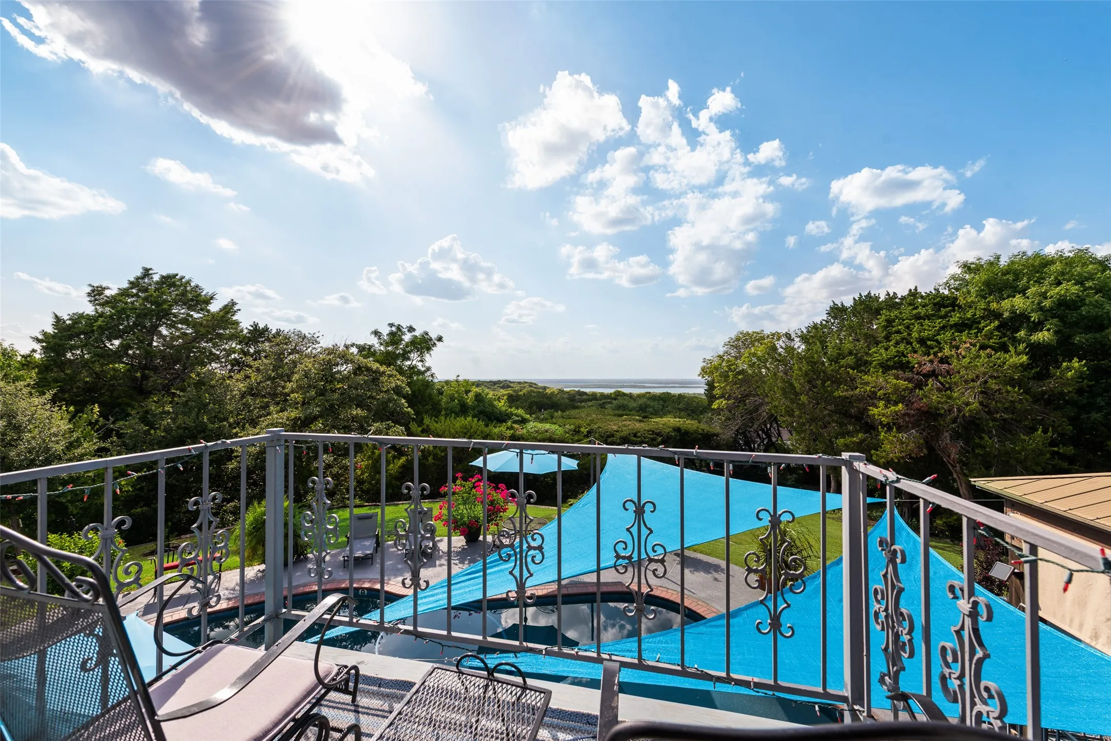 Balcony with ornate metal railing and expansive outdoor scenery