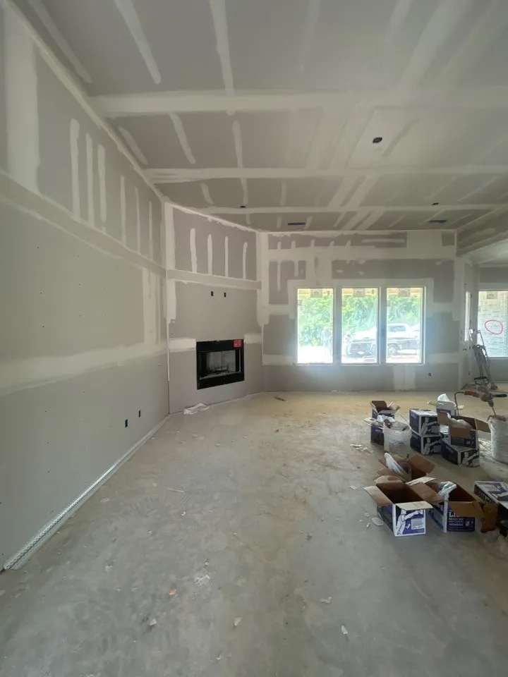 Recessed fireplace, multiple windows, and a tray ceiling
