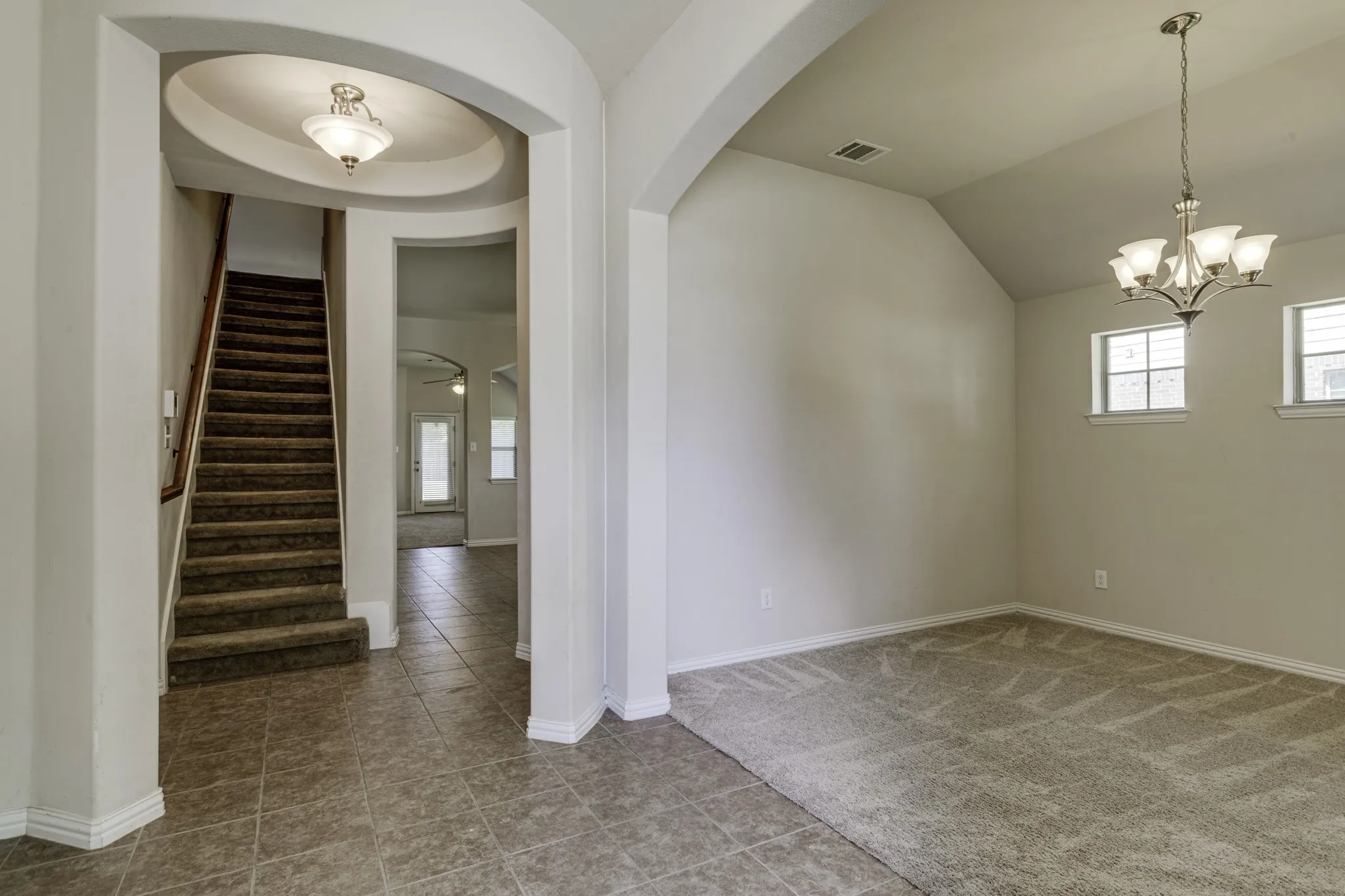As you enter you are greeted by the rounded entry and either a formal living or dining to the right.