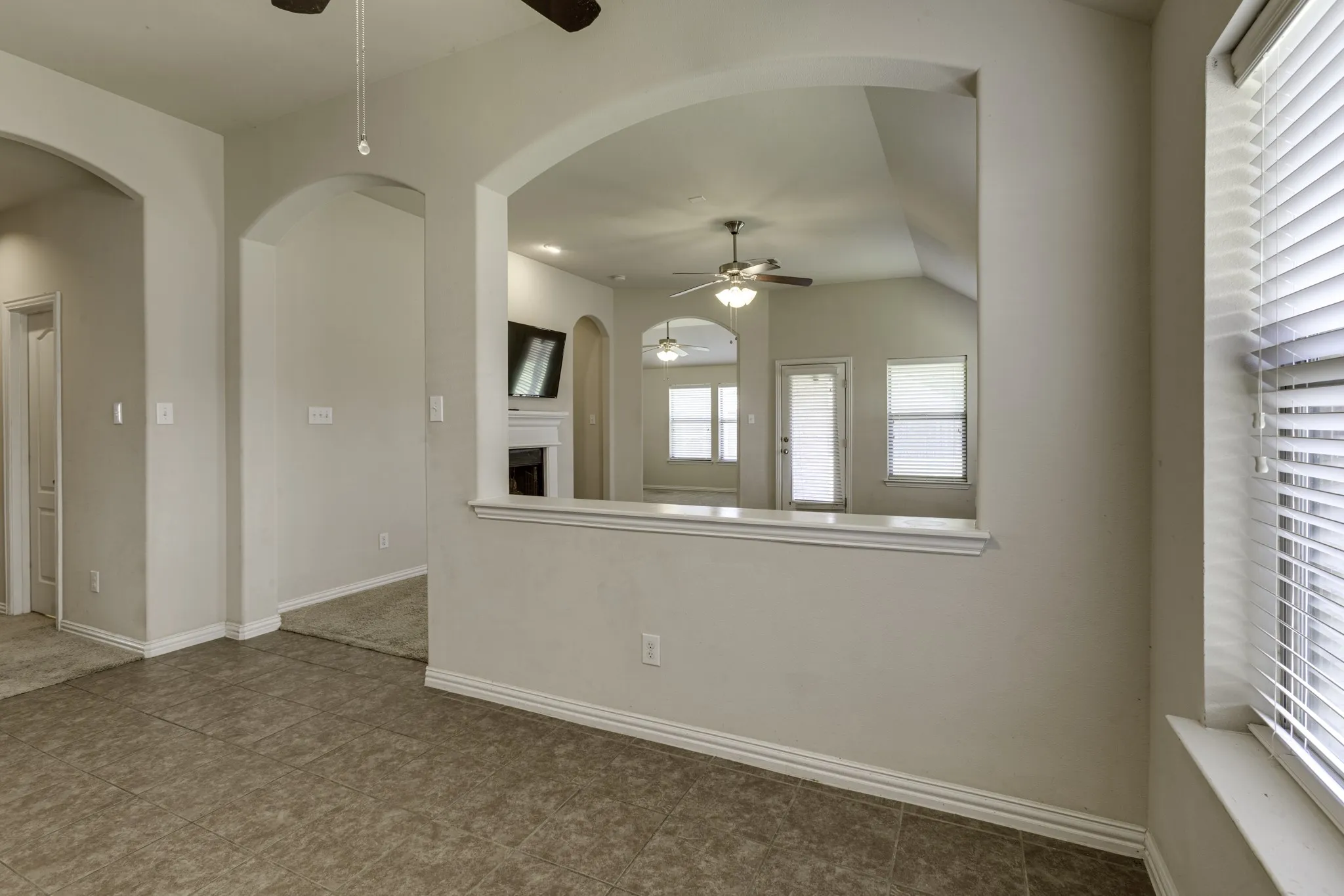 Tile floor and features an arch opening into the living area.
