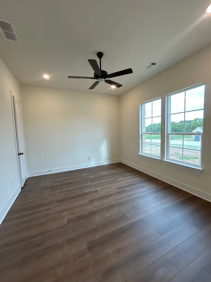 Wood-finish flooring, recessed lighting, and a ceiling fan with integrated lighting