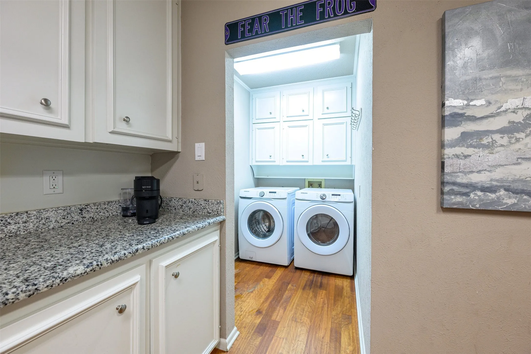 Washer and Dryer situated under built-ins and just off the backyard side entrance.