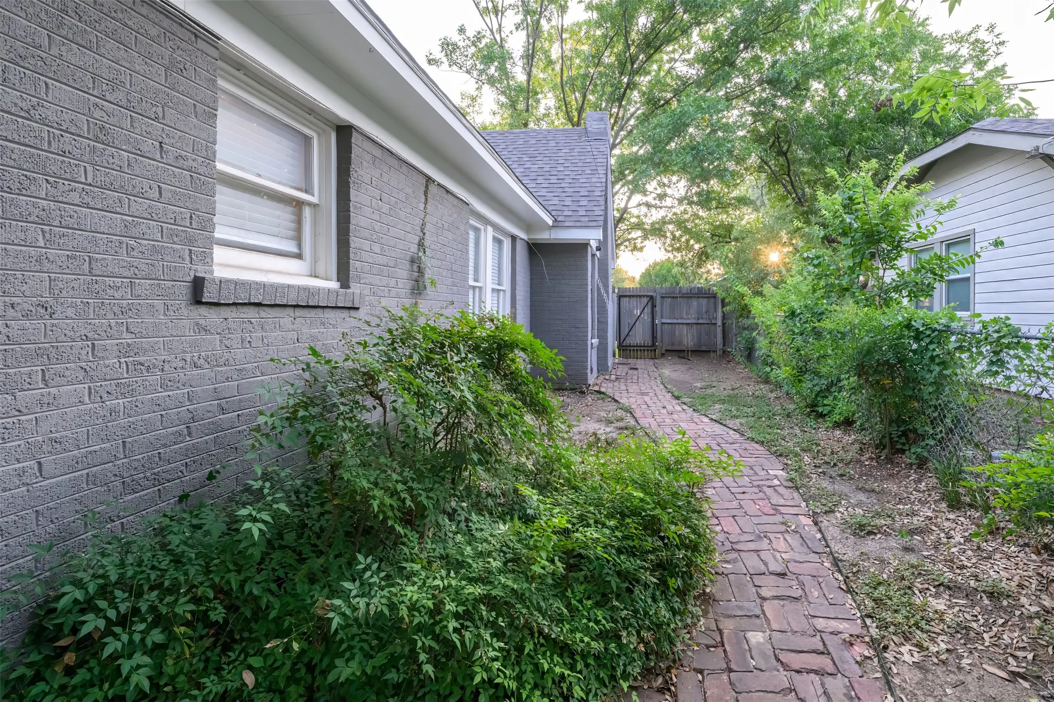 Well maintained side yard leading to the Guest house.