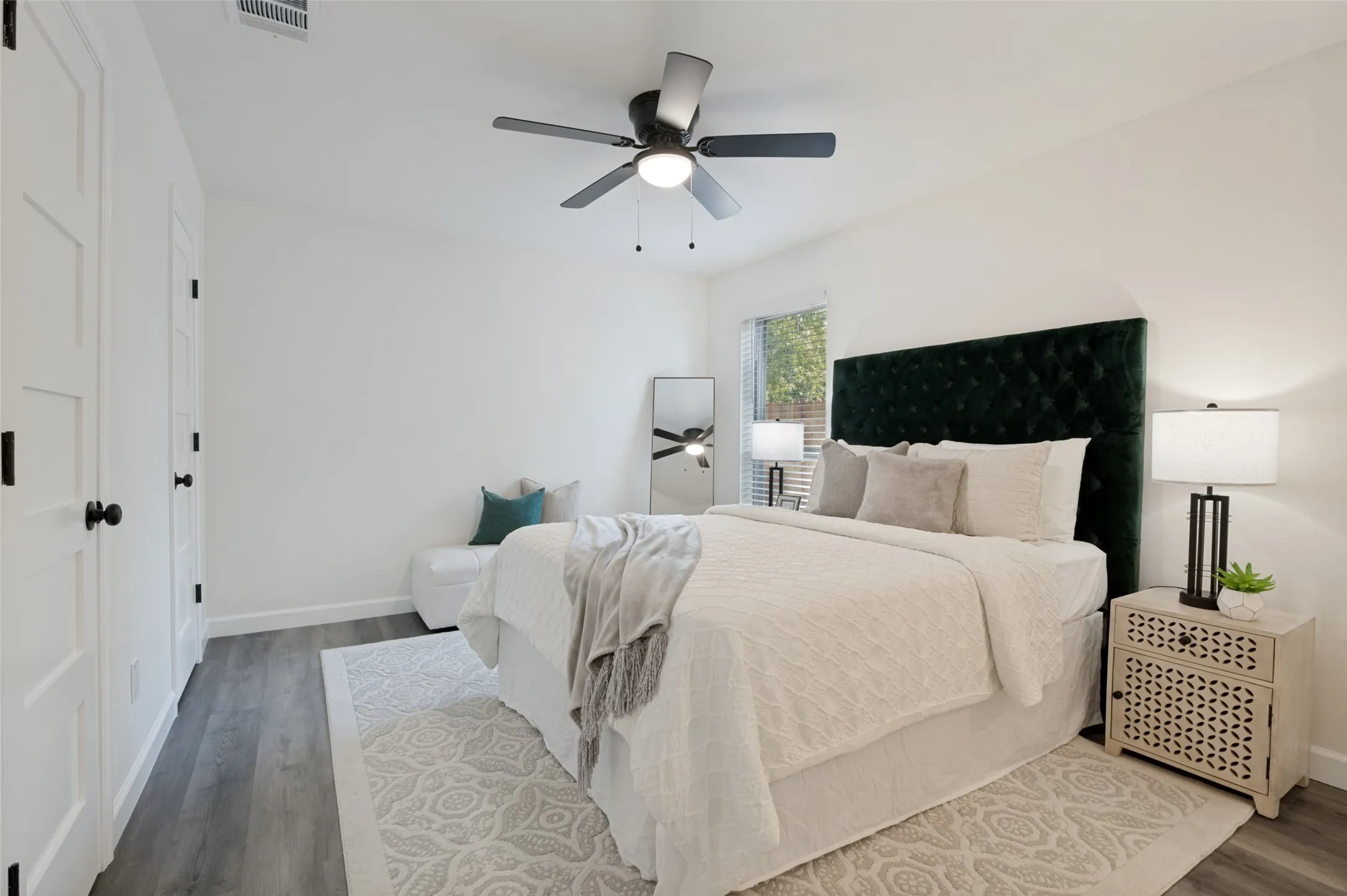 The primary bedroom has plenty of space as shown by the staging!  Double closets a bonus!