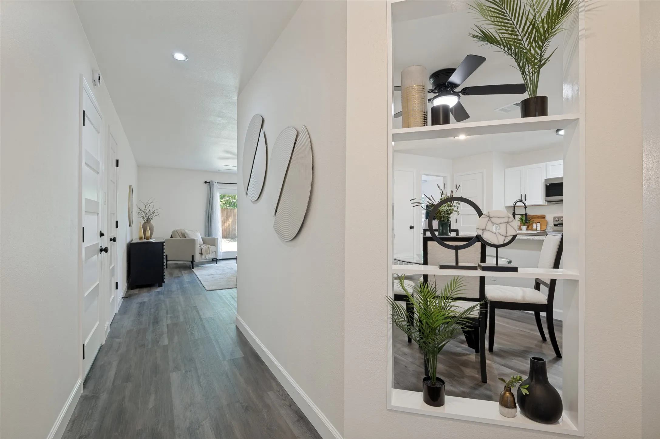 This is the view as you walk in the beautiful front door into the hallway.  Fabulous open shelving peeks into the dining area.