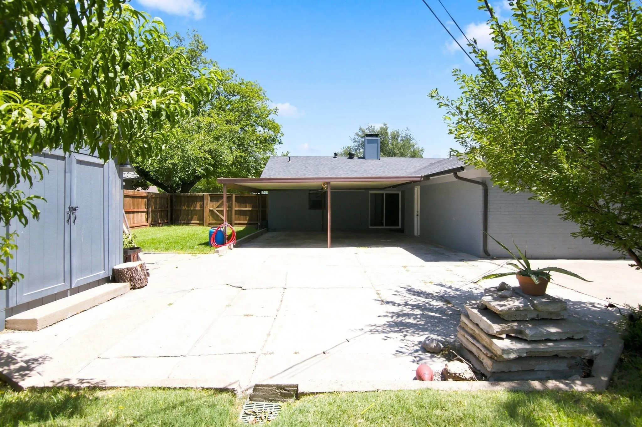 View of carport and storage shed
