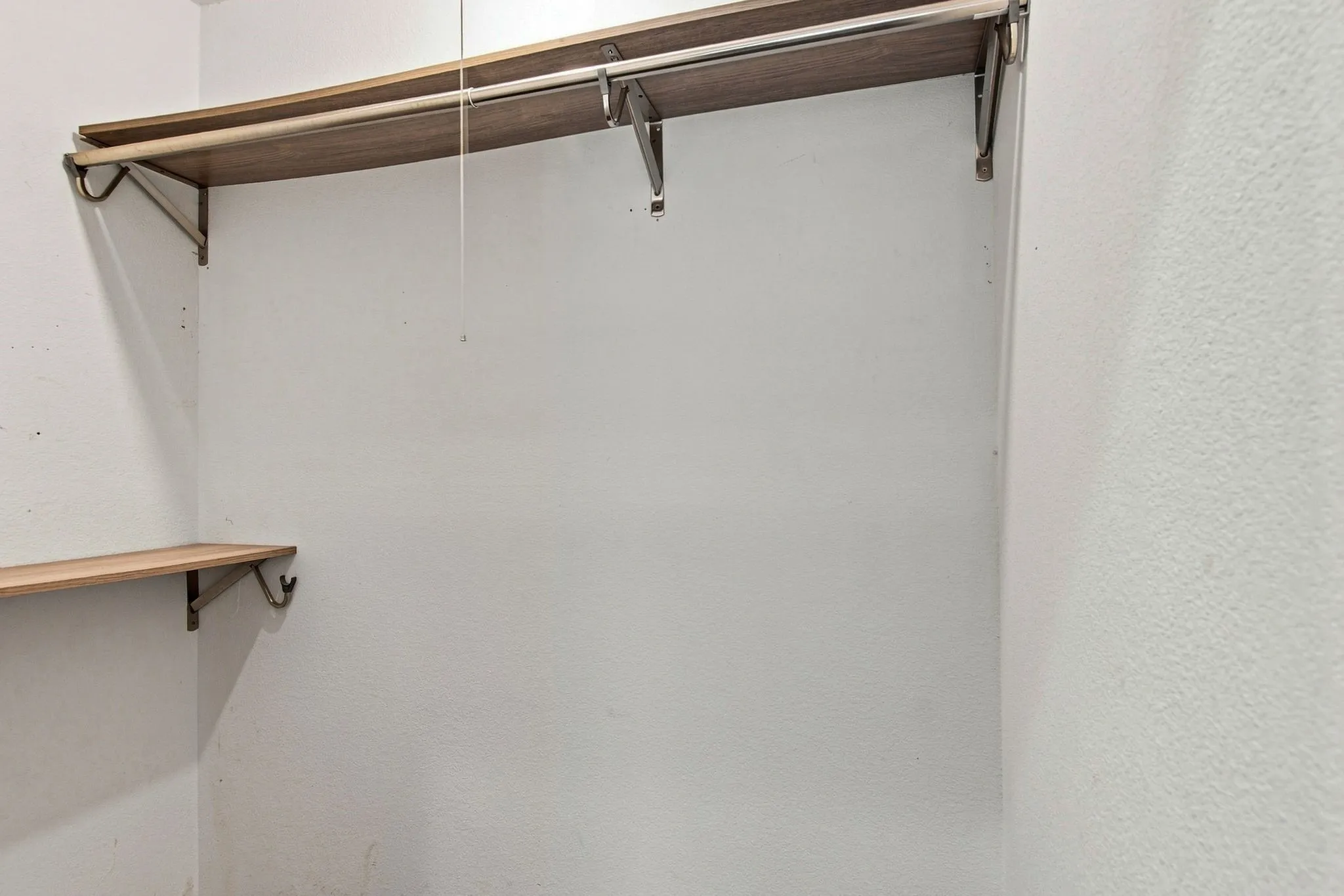 Built-in shelving with wood-finish surfaces and metal support brackets