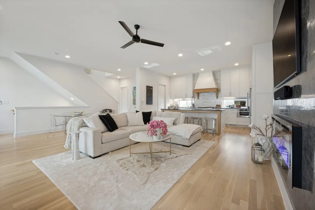 Open-concept living space featuring wood-finish flooring, recessed lighting, and a modern ceiling fan