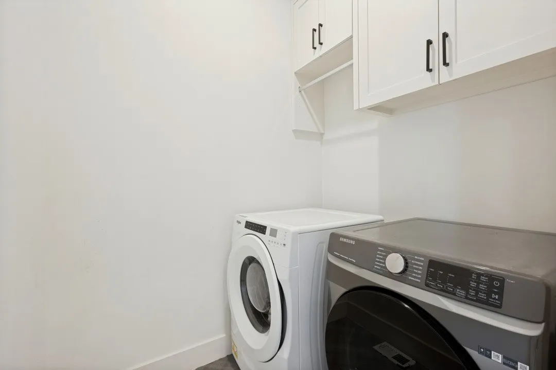 White shaker-style cabinetry with matte black hardware