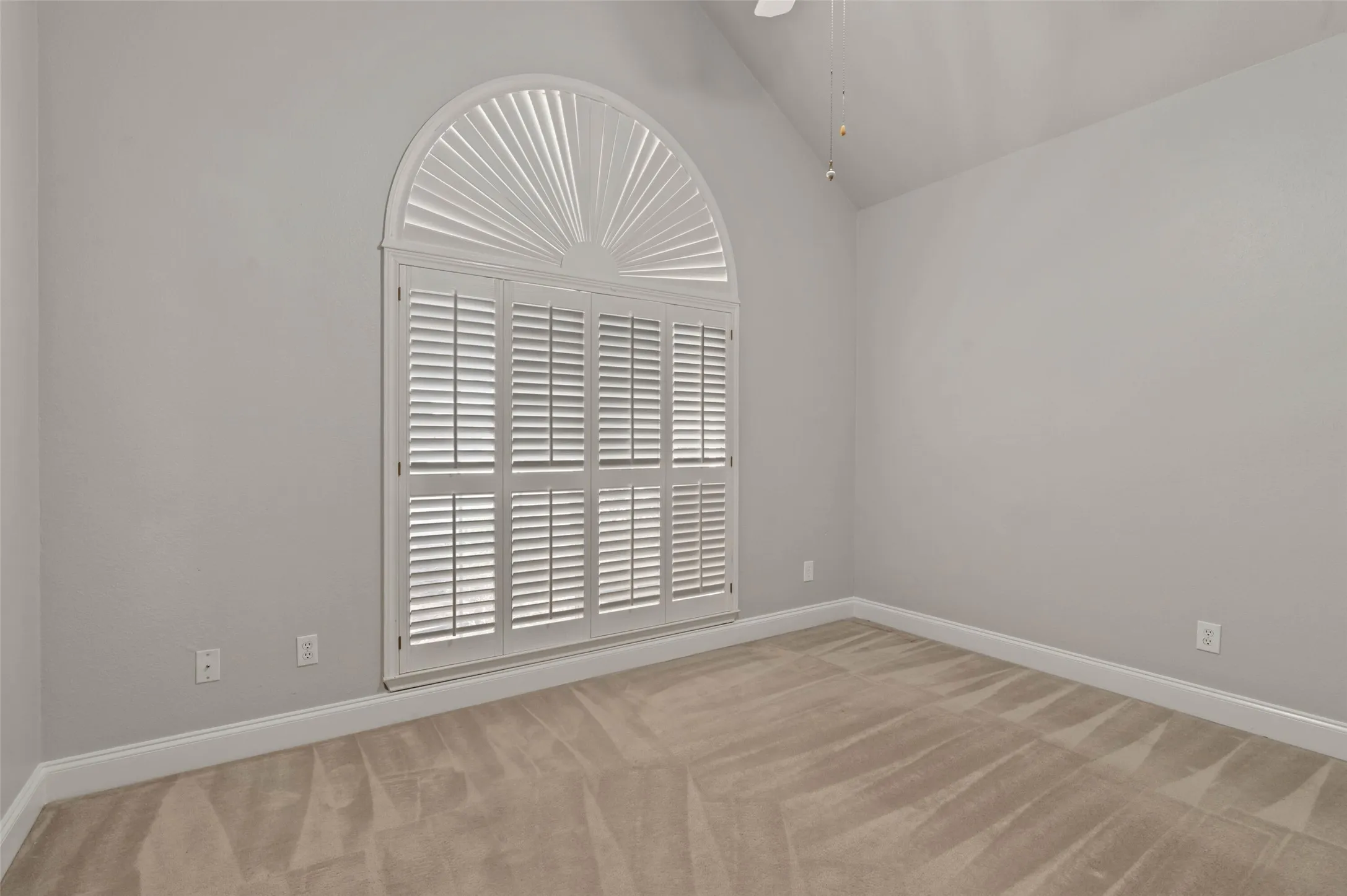 Office/study with carpeted flooring, french doors and plantation style shutters.