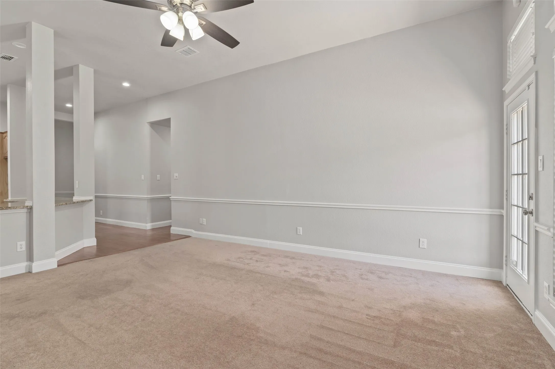 Spacious living area with plenty of windows, gas fireplace and back door opening to the beautiful back yard and pool area.