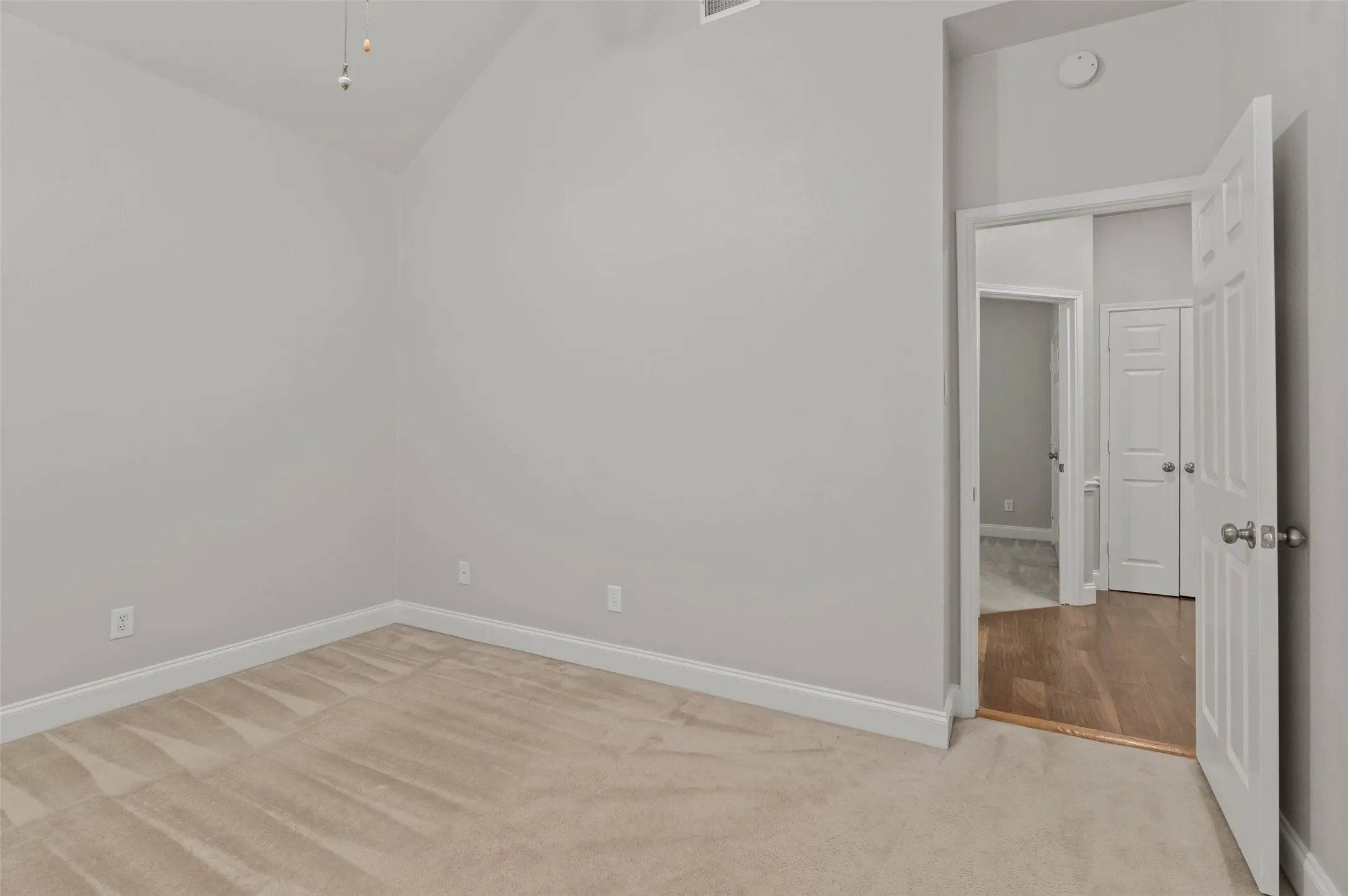Bedroom with carpeted flooring and ceiling fan.