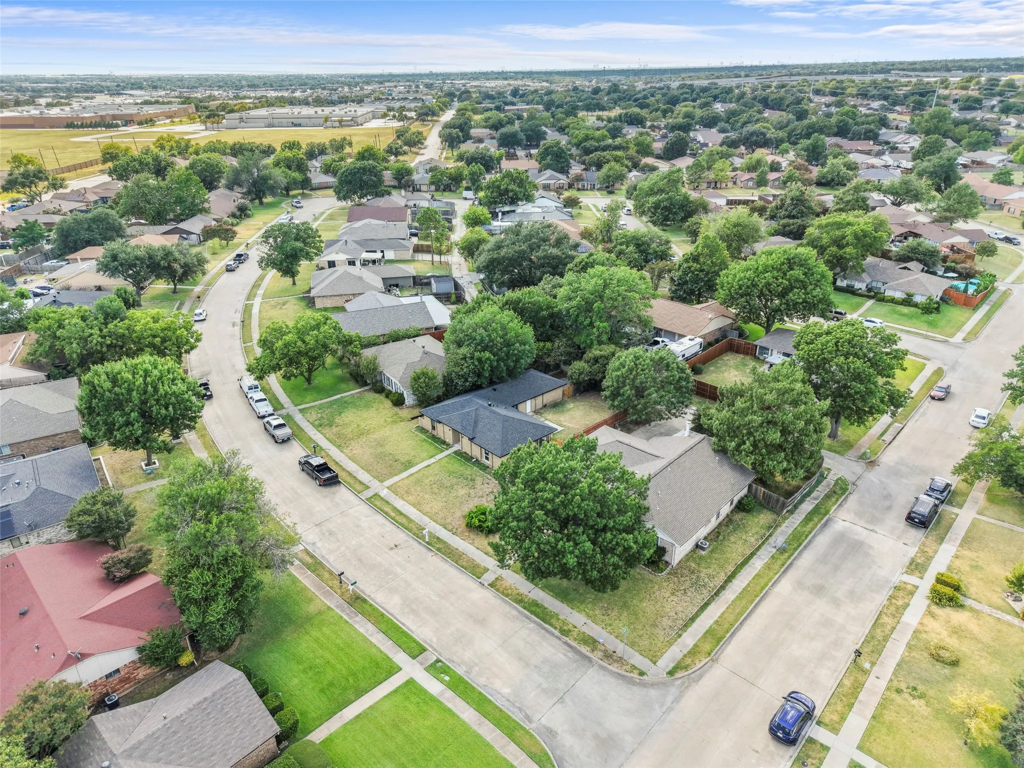 Residential neighborhood with mature trees and paved streets