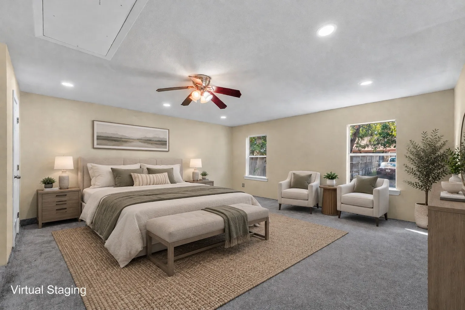 Spacious room featuring ceiling-mounted lighting, a ceiling fan, two windows, and gray carpeting