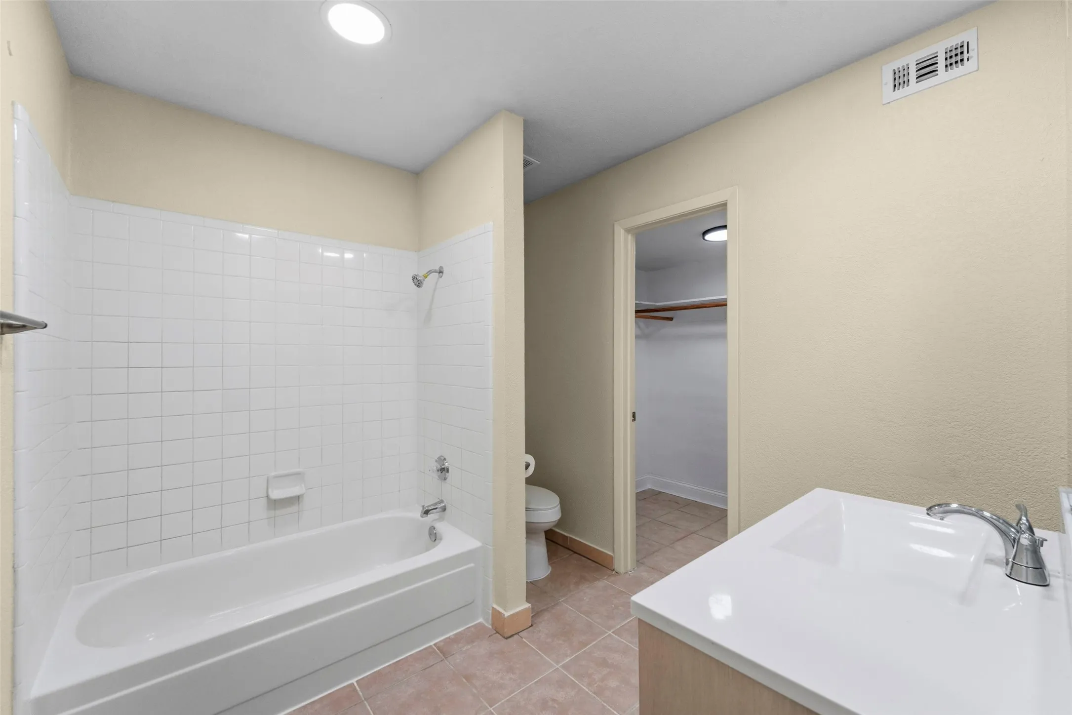 White subway tile shower surround with integrated bathtub