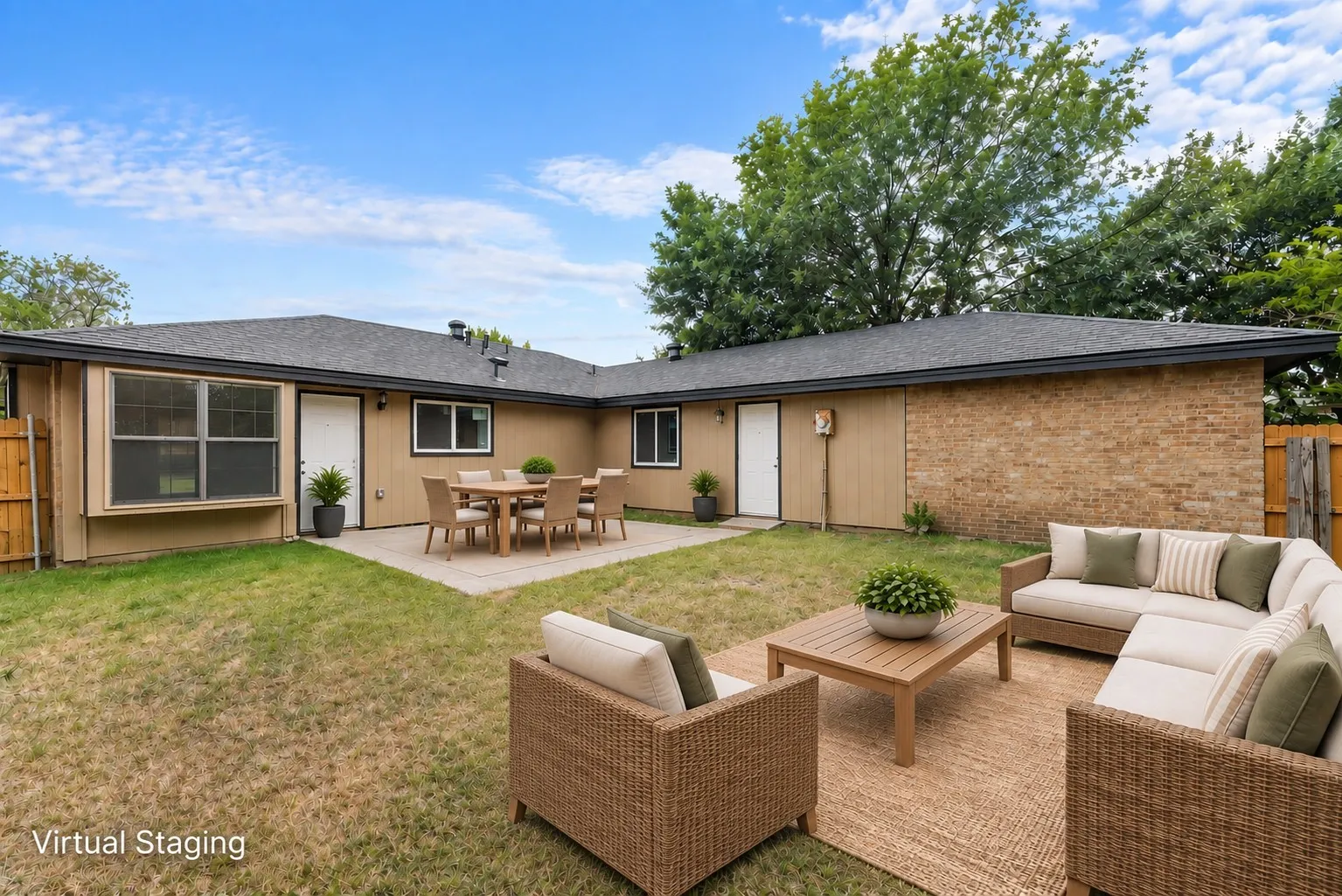 Expansive backyard with a concrete patio, brick and siding exterior, and a dark shingle roof