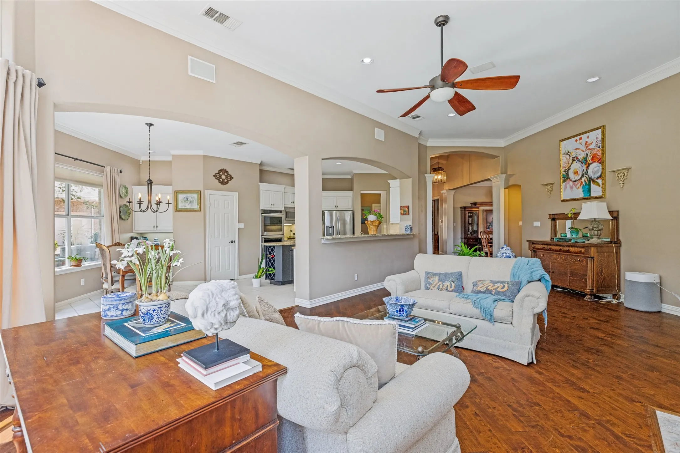 Wood flooring sets off the room, that is open to the kitchen.