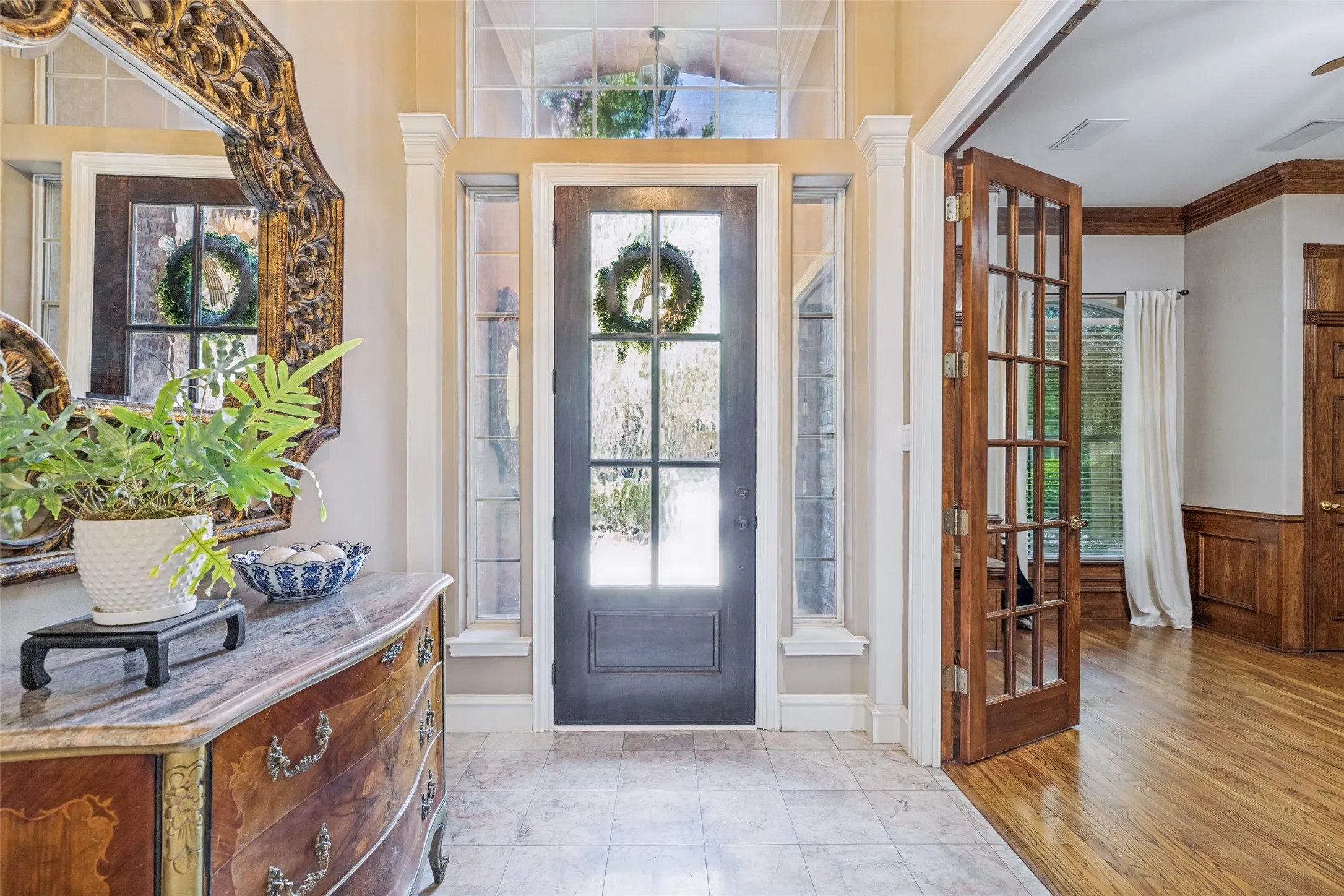 Quaint entry, into the foyer and office with french doors to the left.