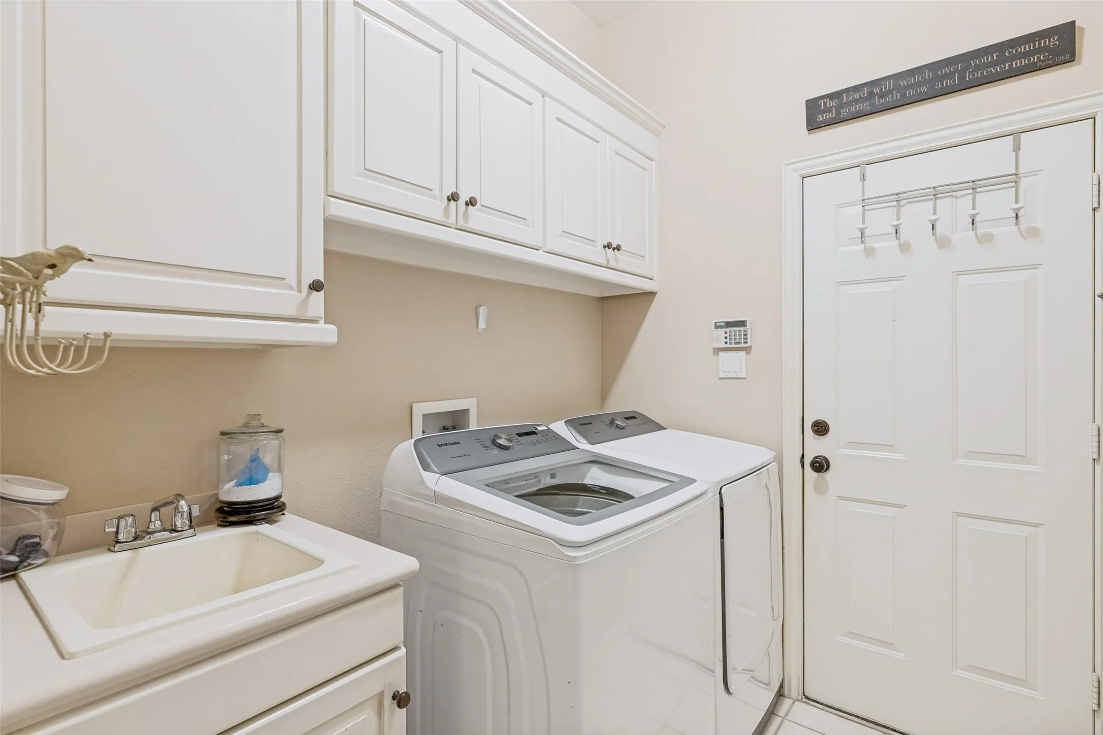 Cabinets and sink in the laundry room.