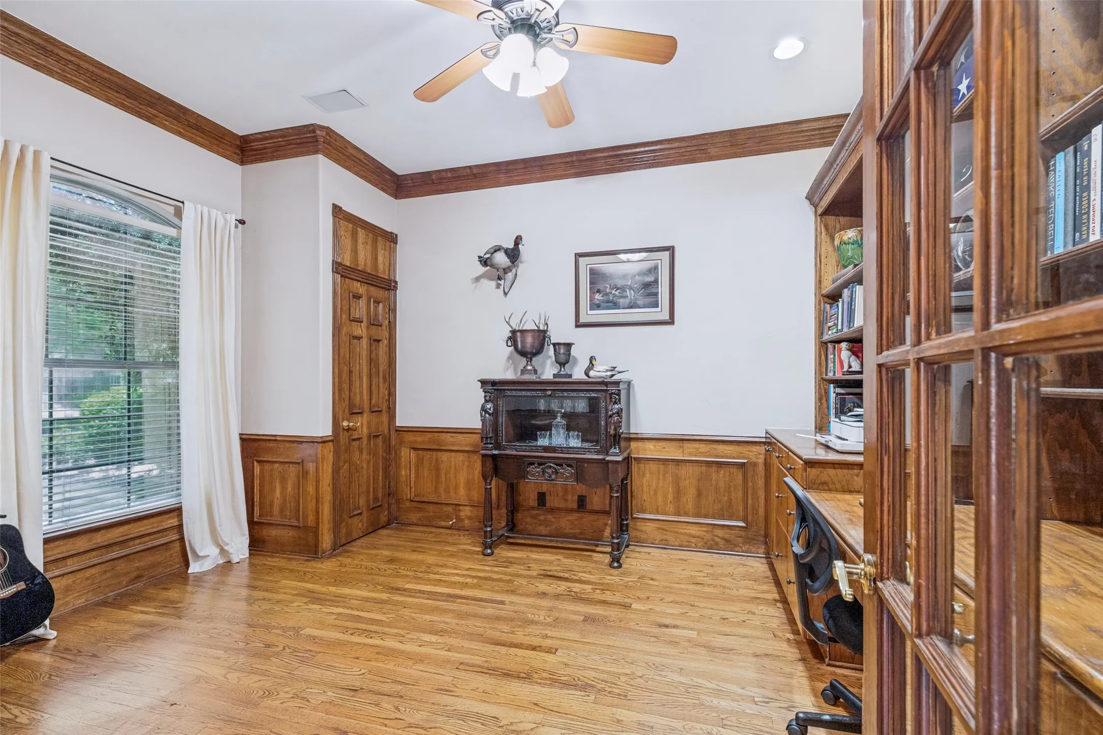 Office or library with built-in shelving and 2 closets.