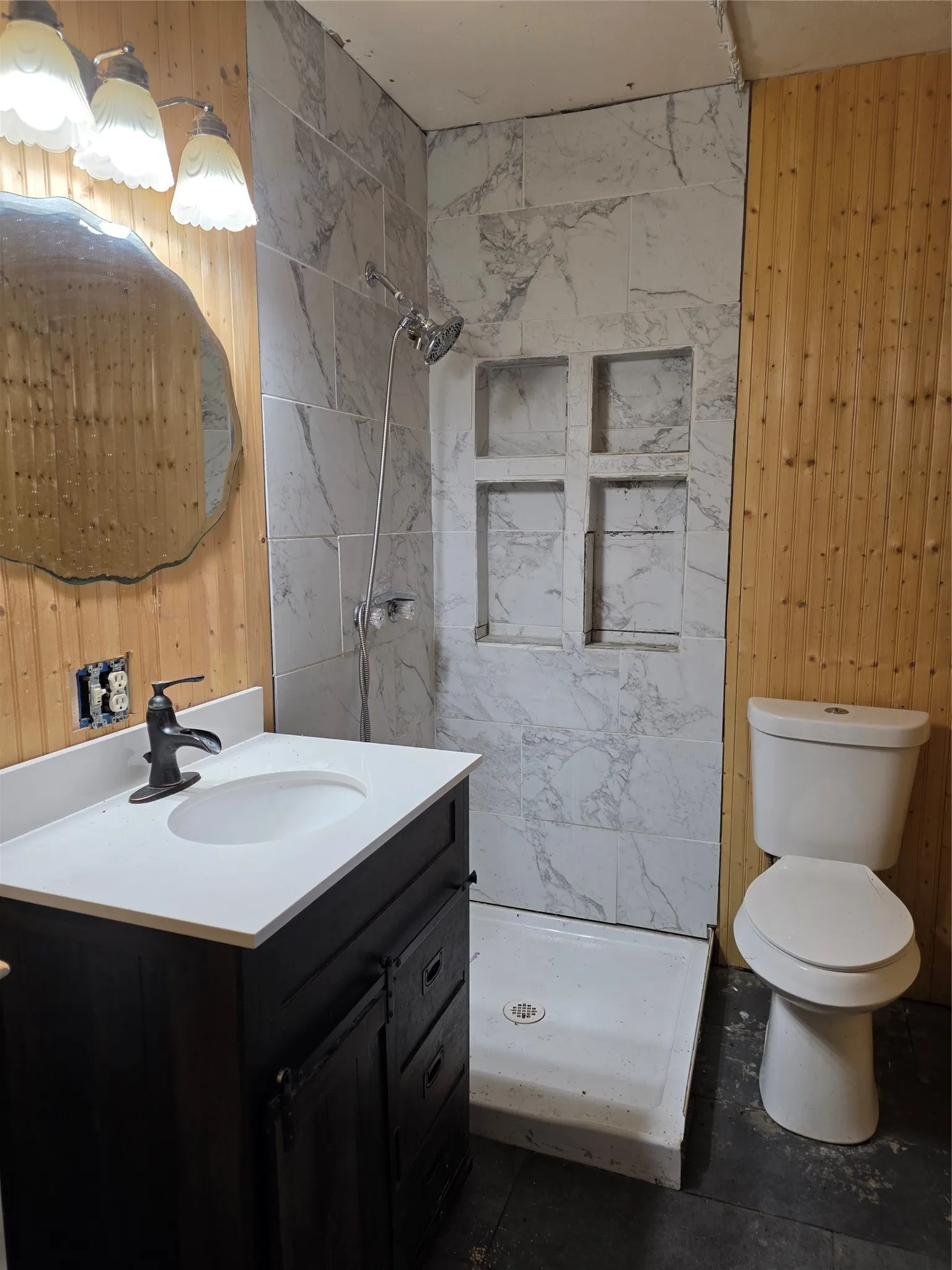 Vanity with integrated sink, oil-rubbed bronze faucet, and white countertop