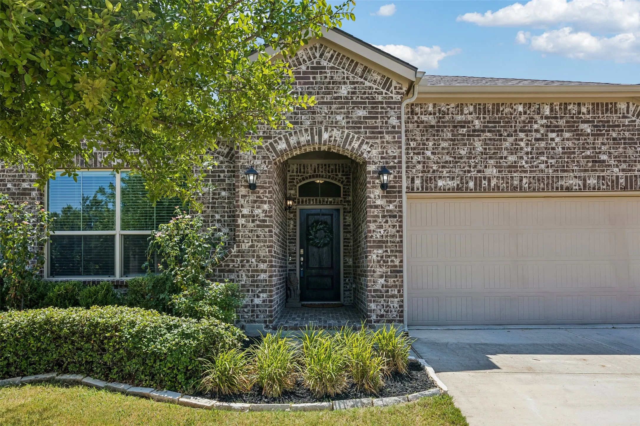 Inviting curb appeal with attached two-car garage, mature landscaping and concrete​​‌​​​​‌​​‌‌​‌‌​​​‌‌​‌​‌​‌​​​‌​​ driveway