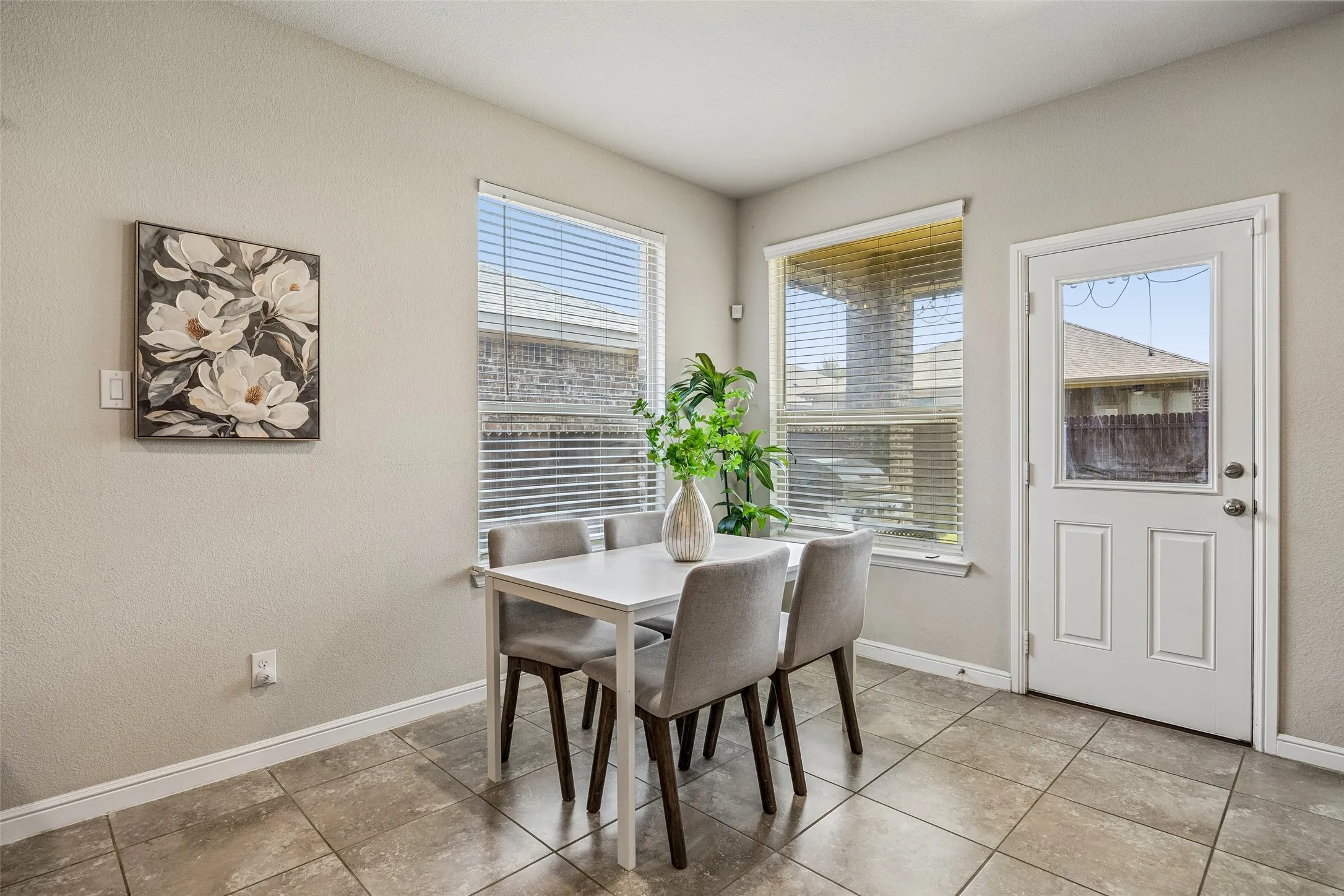 Tile flooring, light-toned walls, and a glass-paneled exterior door