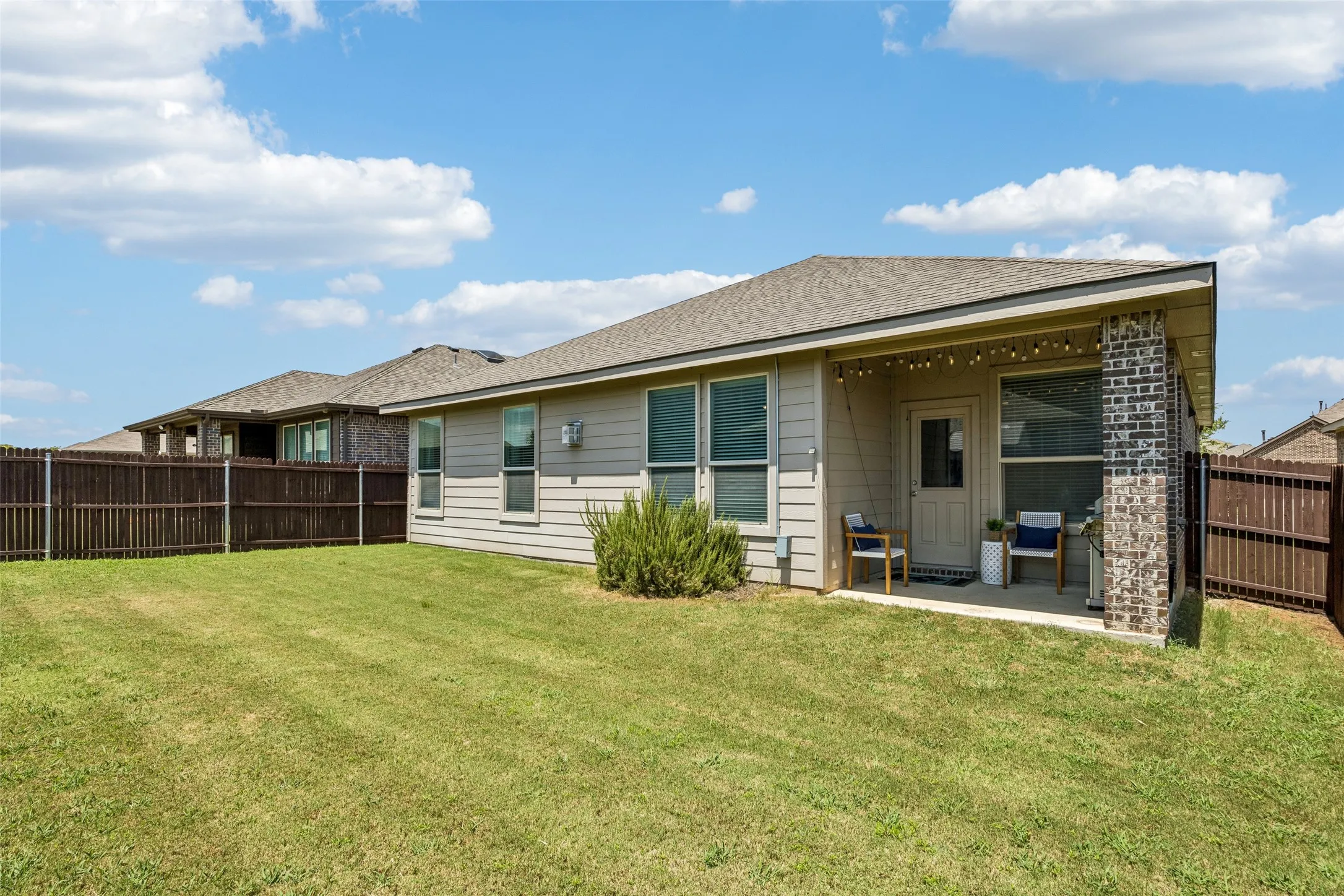 Expansive rear yard with a concrete patio