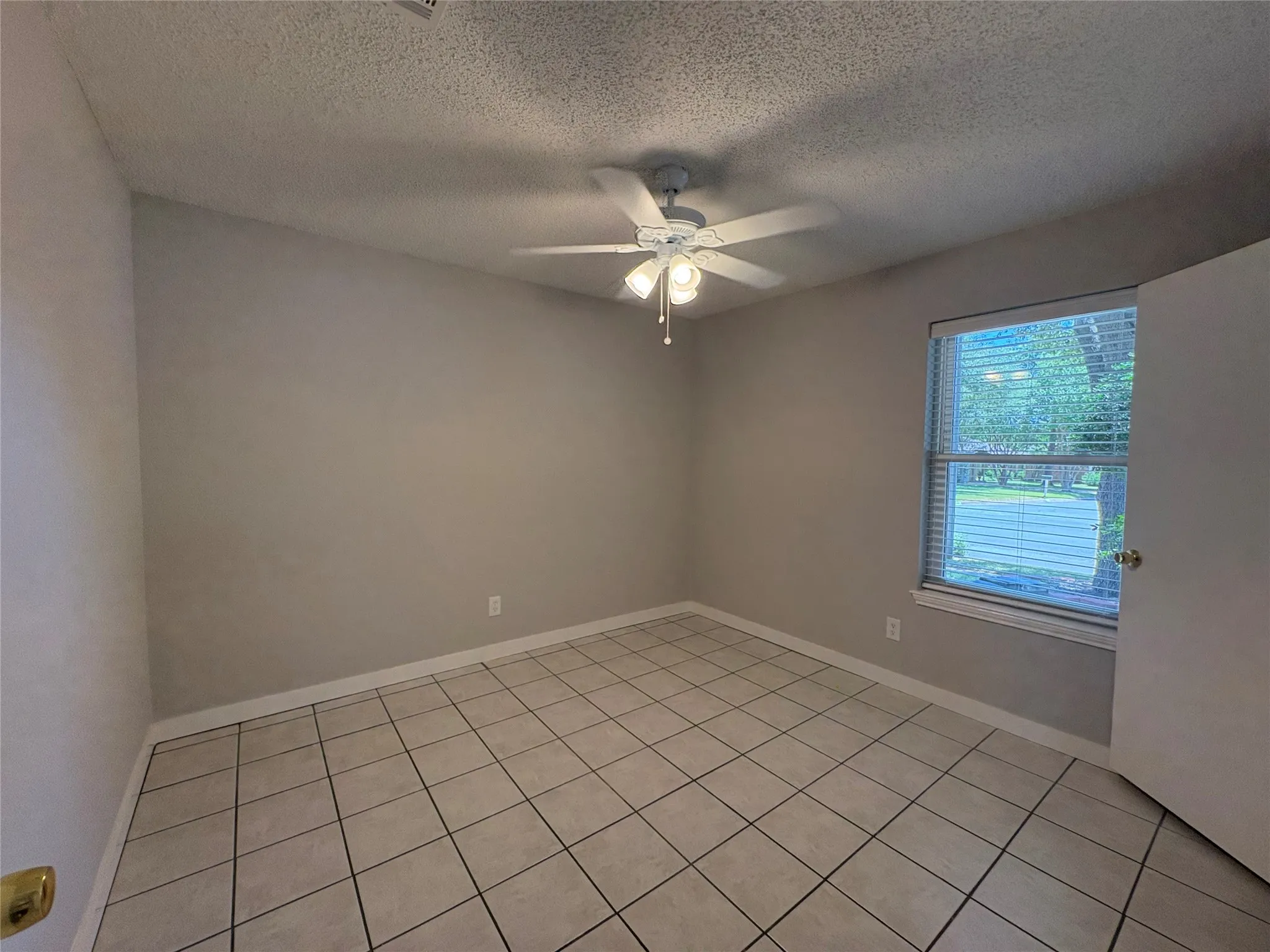 One of the two spacious secondary bedroom, both with ciling fans and good sized closets.