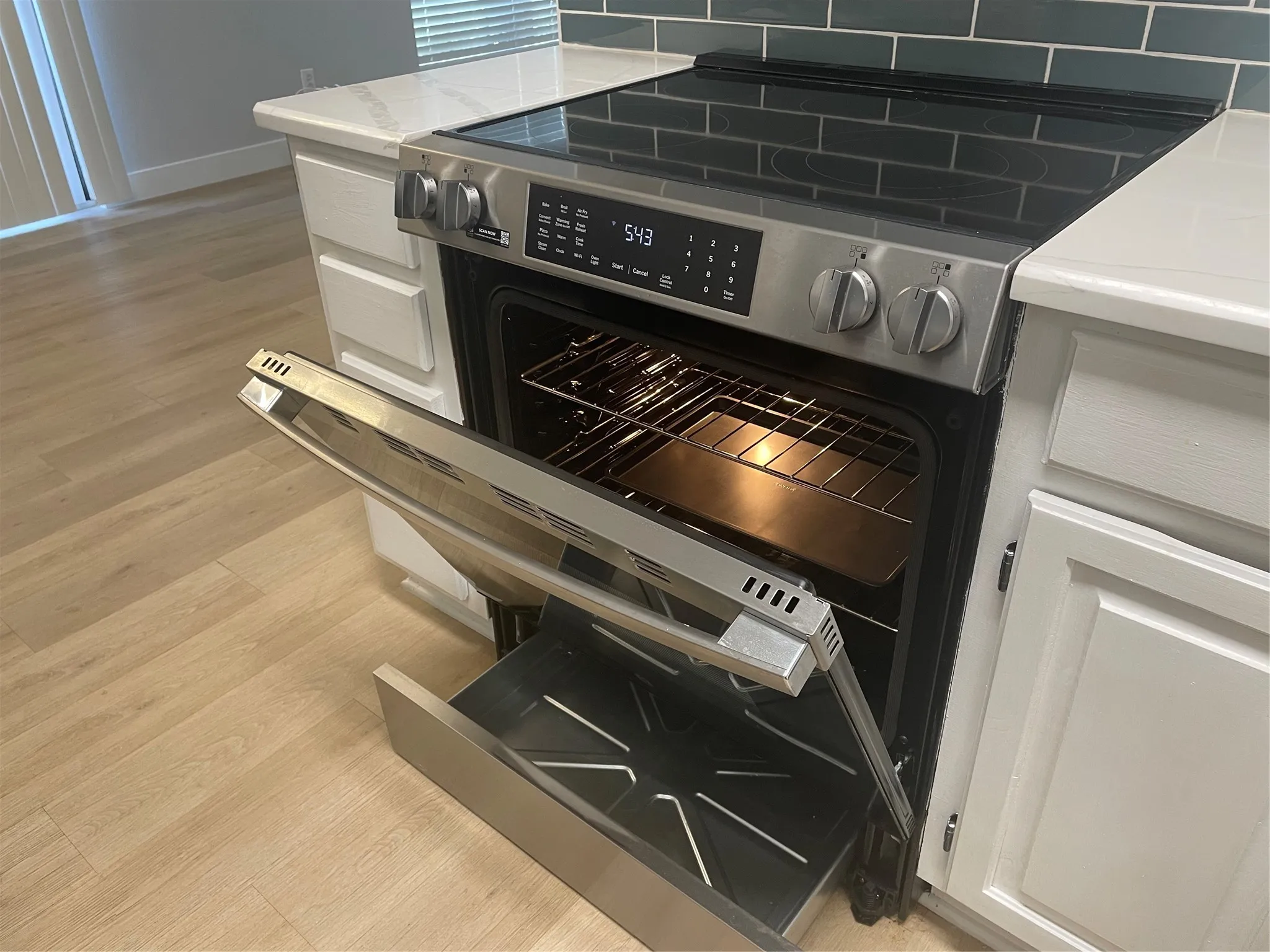 Modern stainless steel dual wall oven with convection cooking, positioned within custom white cabinetry