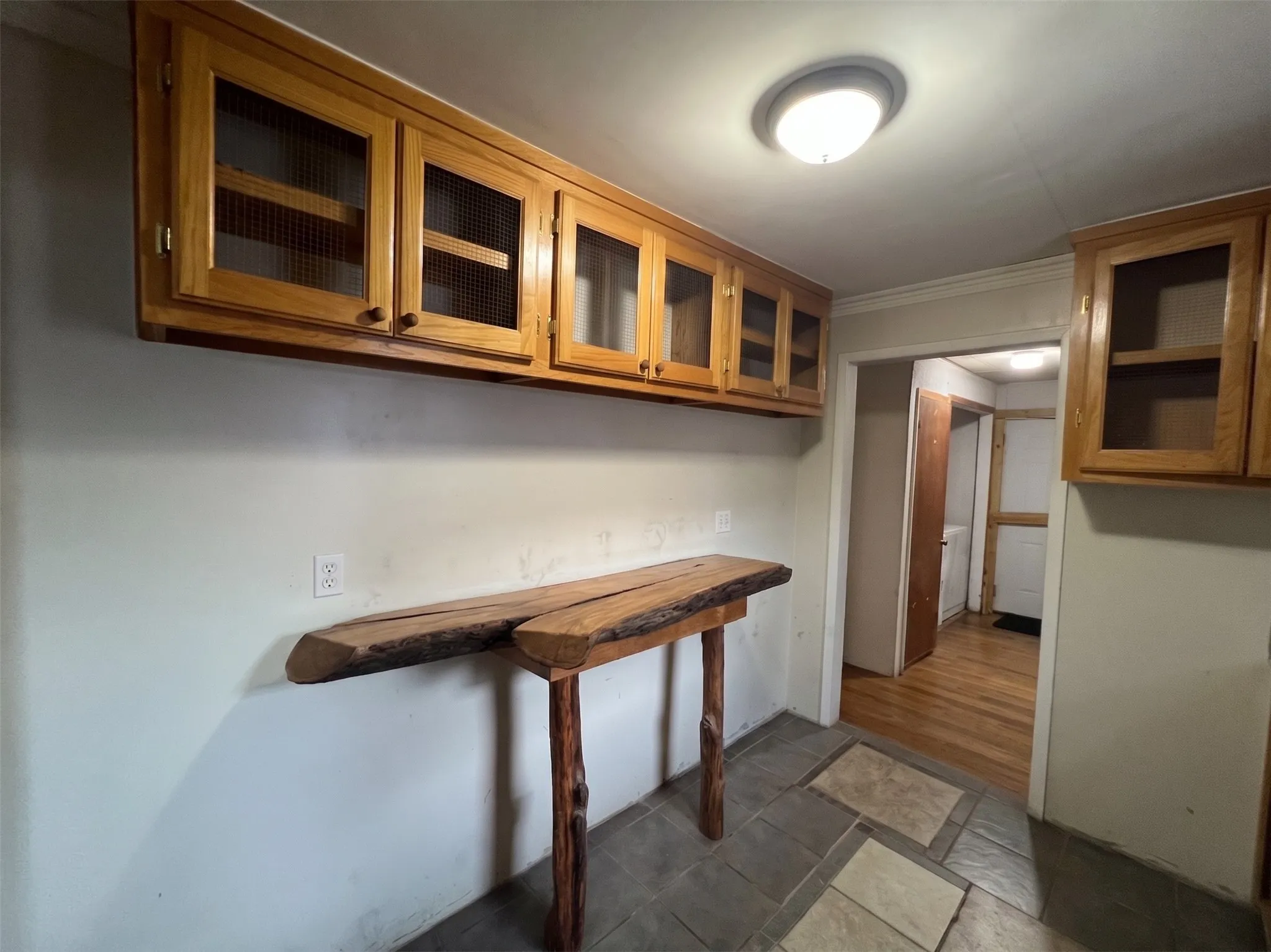 Additional cabinets with entry to utility room leading to backyard.
