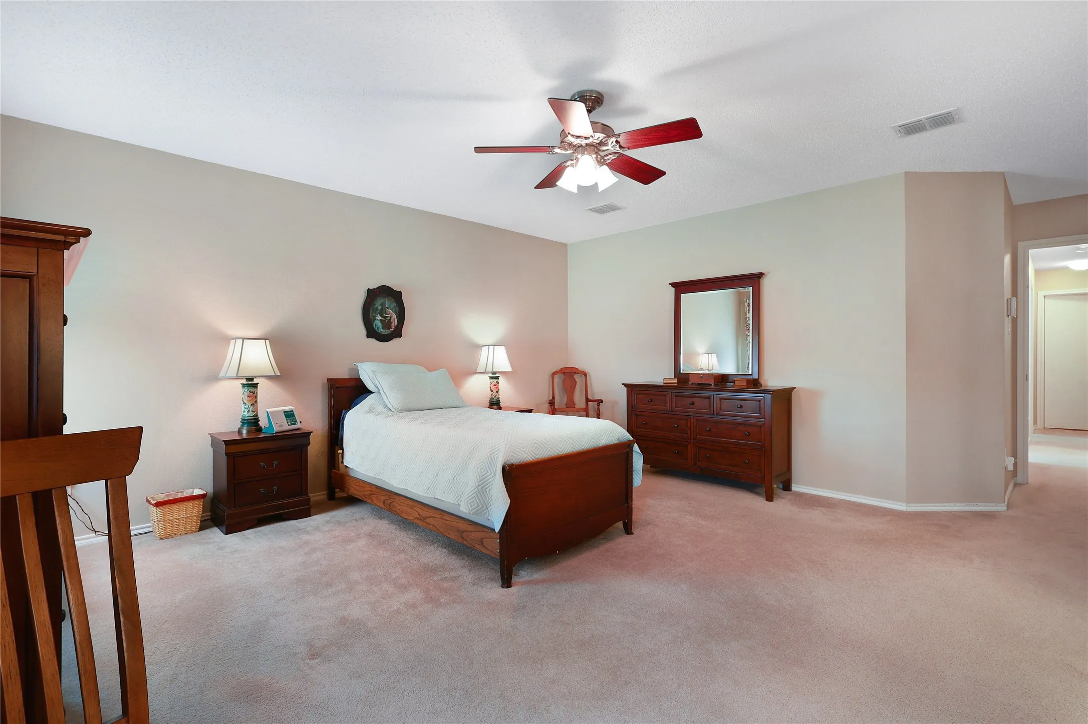 Neutral painted walls with recessed lighting and a ceiling fan
