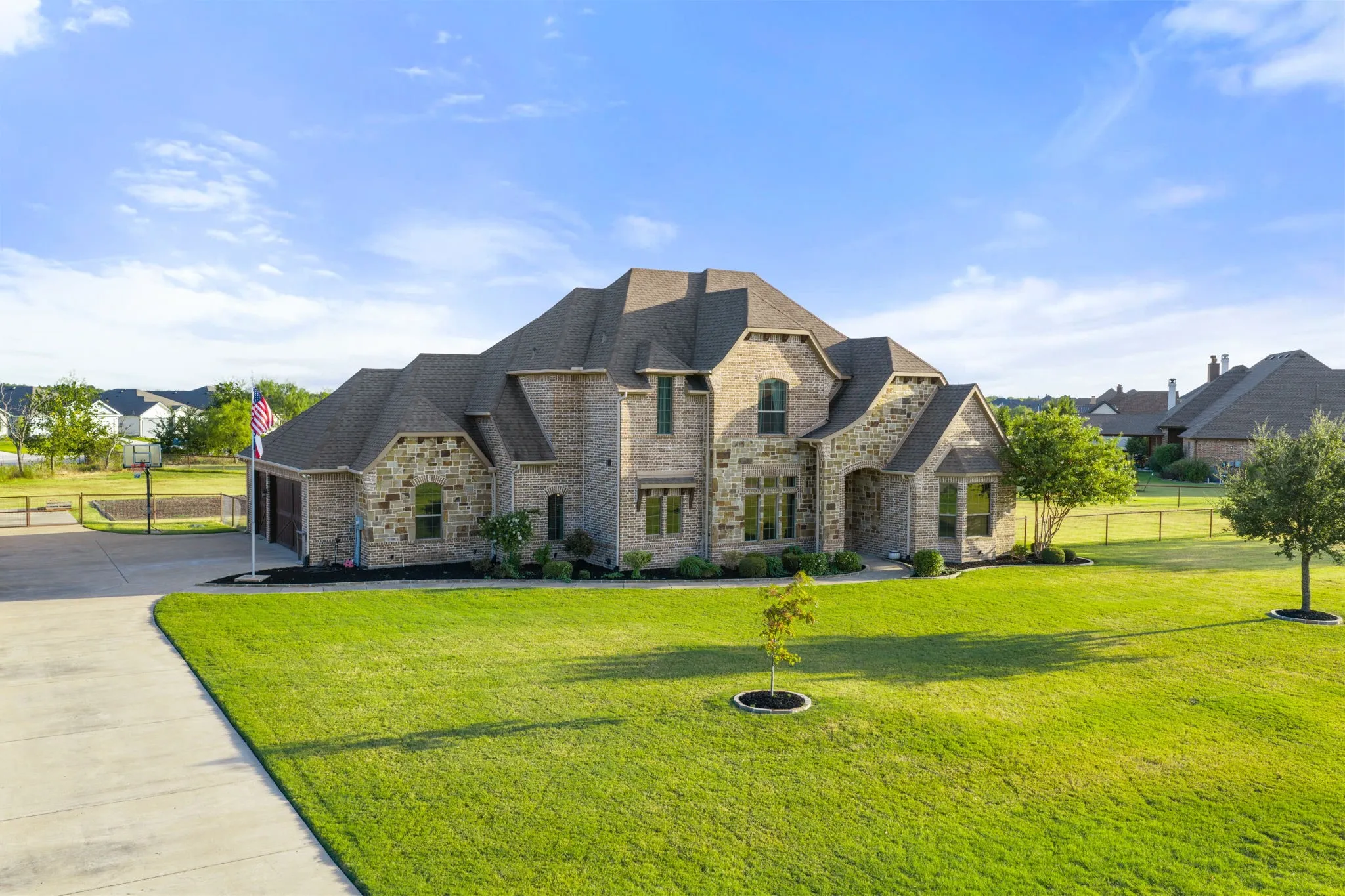 Brick and stone exterior with multiple gables and a covered entryway