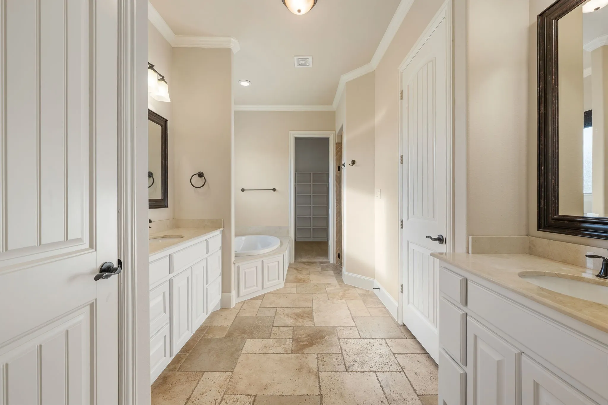 Dual vanities, built-in soaking tub, tile flooring, white shaker cabinetry, and recessed lighting