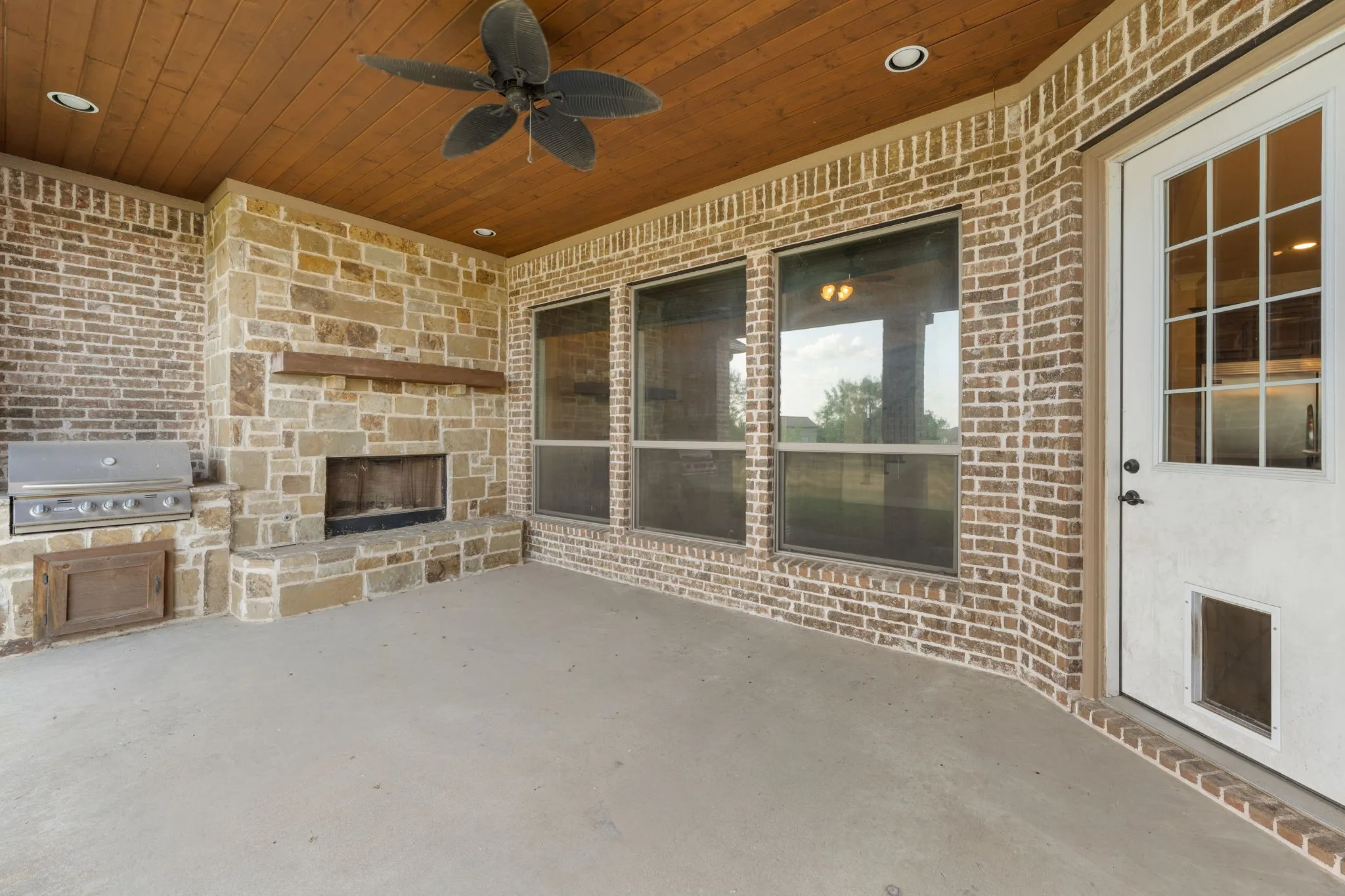 Covered patio featuring a wood-plank ceiling, ceiling fan, and recessed lighting