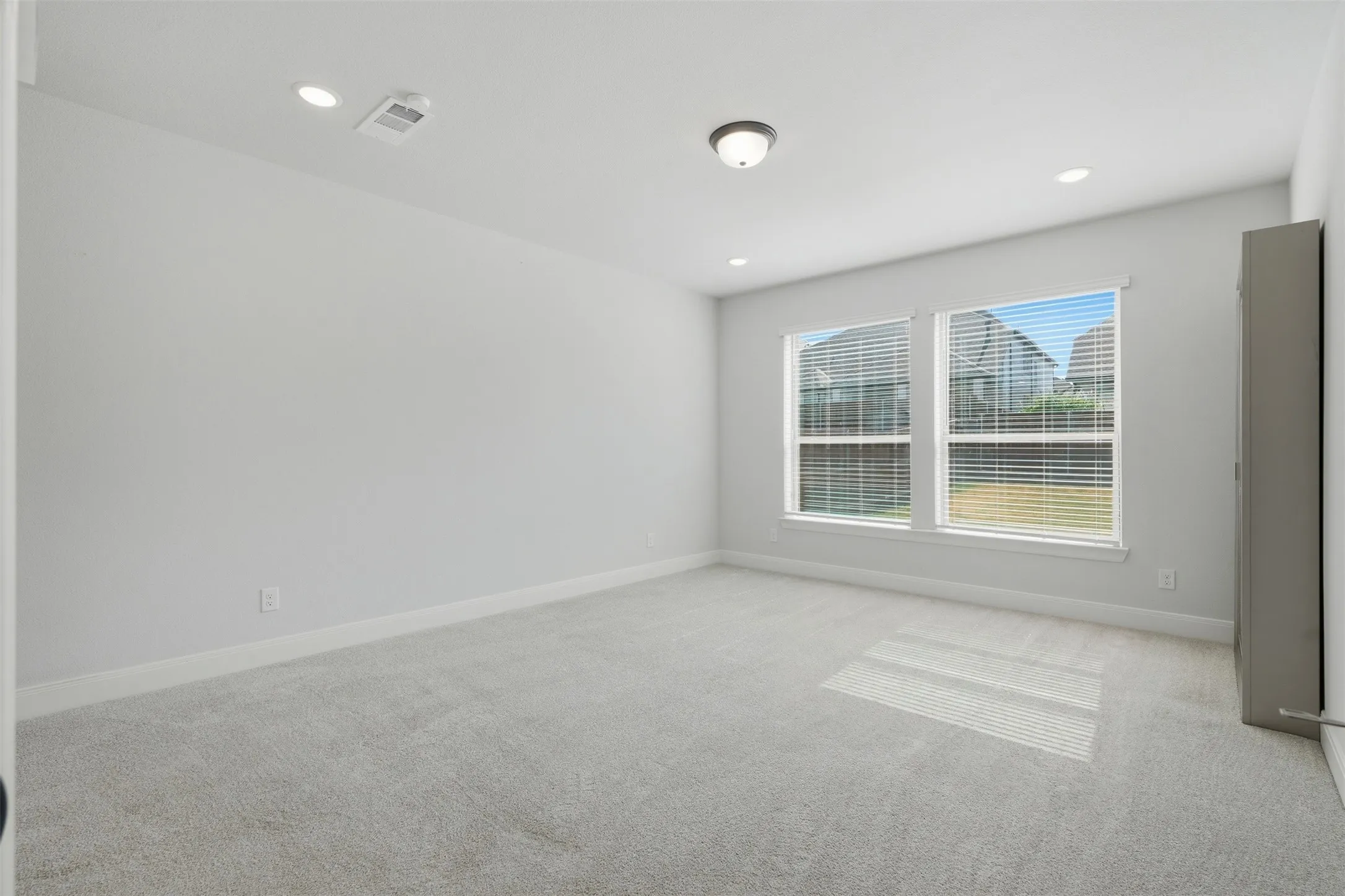 Comfortable carpeted bedroom offering a warm, inviting atmosphere with a soft underfoot feel and a versatile layout for restful everyday living