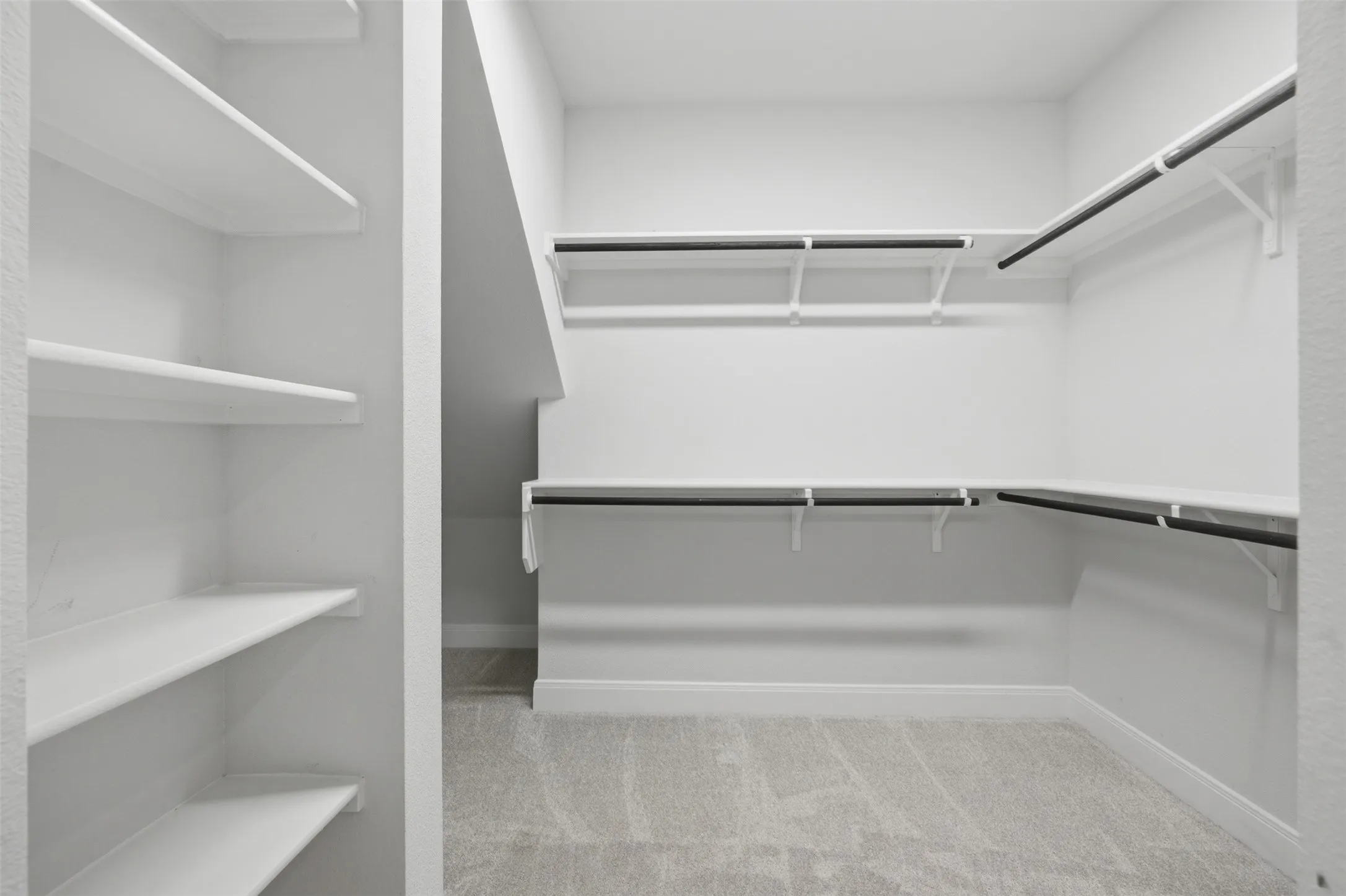 Custom built-in closet featuring integrated shelving and hanging rods, offering a streamlined storage solution with easy organization