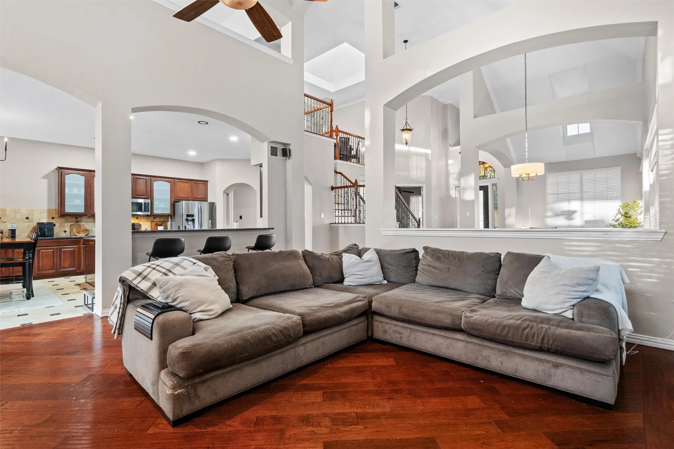 Warm hardwood floors and soaring ceilings create an impressive gathering space.
