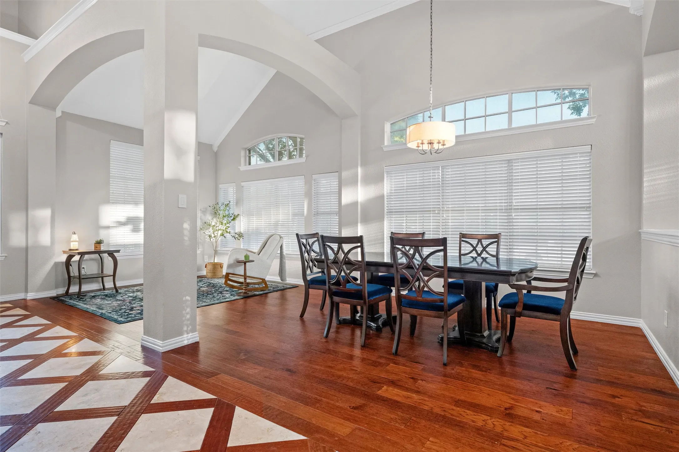 Light filled living and dining spaces with soaring ceilings and seamless flow for entertaining.