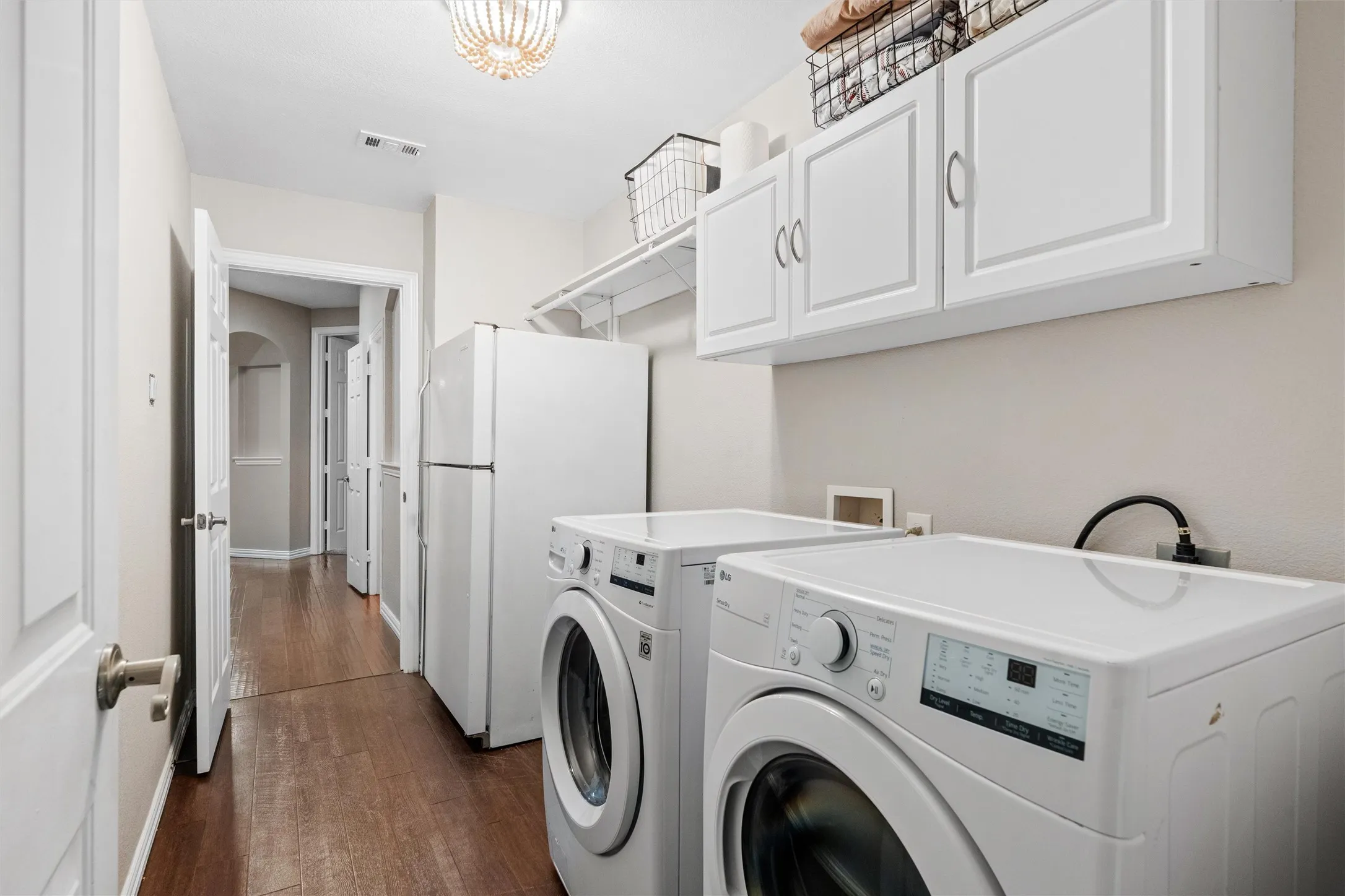 Nice sized laundry room with space for an extra fridge