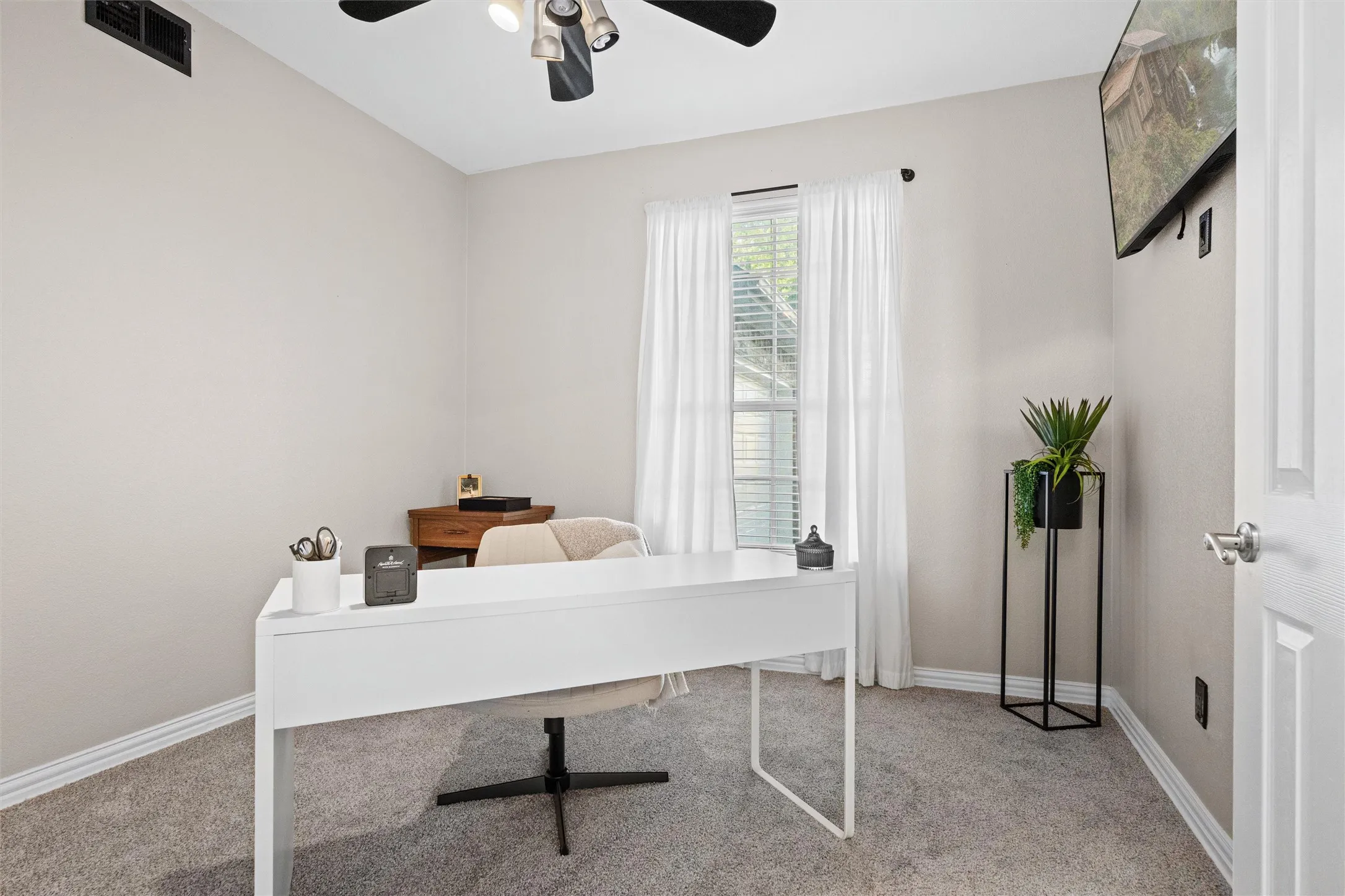 Dedicated home office with natural light and a quiet setting ideal for remote work, studying, or creative pursuits.