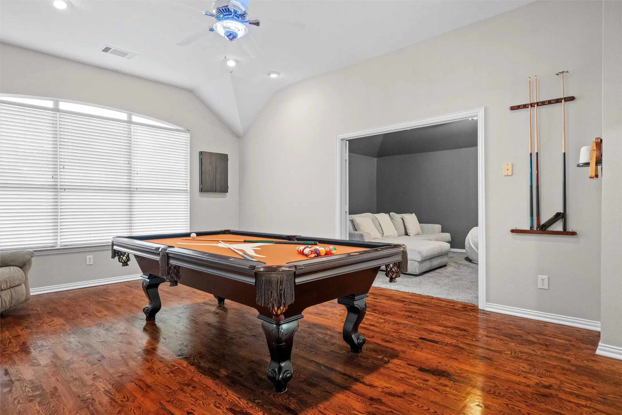 Expansive game room featuring wood flooring and adjacent to the home theater.