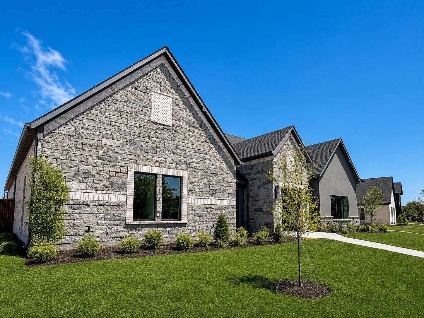 Stone and brick exterior with dark-framed windows