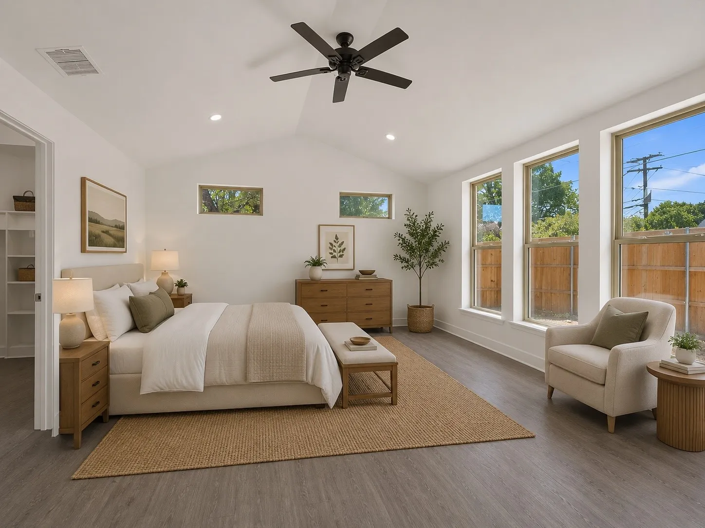 Vaulted ceiling, recessed lighting, wood-finish flooring, multiple windows, built-in closet shelving