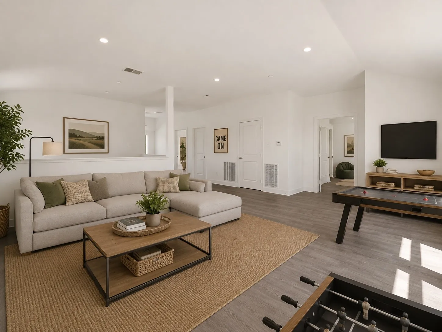 Vaulted ceilings, recessed lighting, and wood-finish flooring