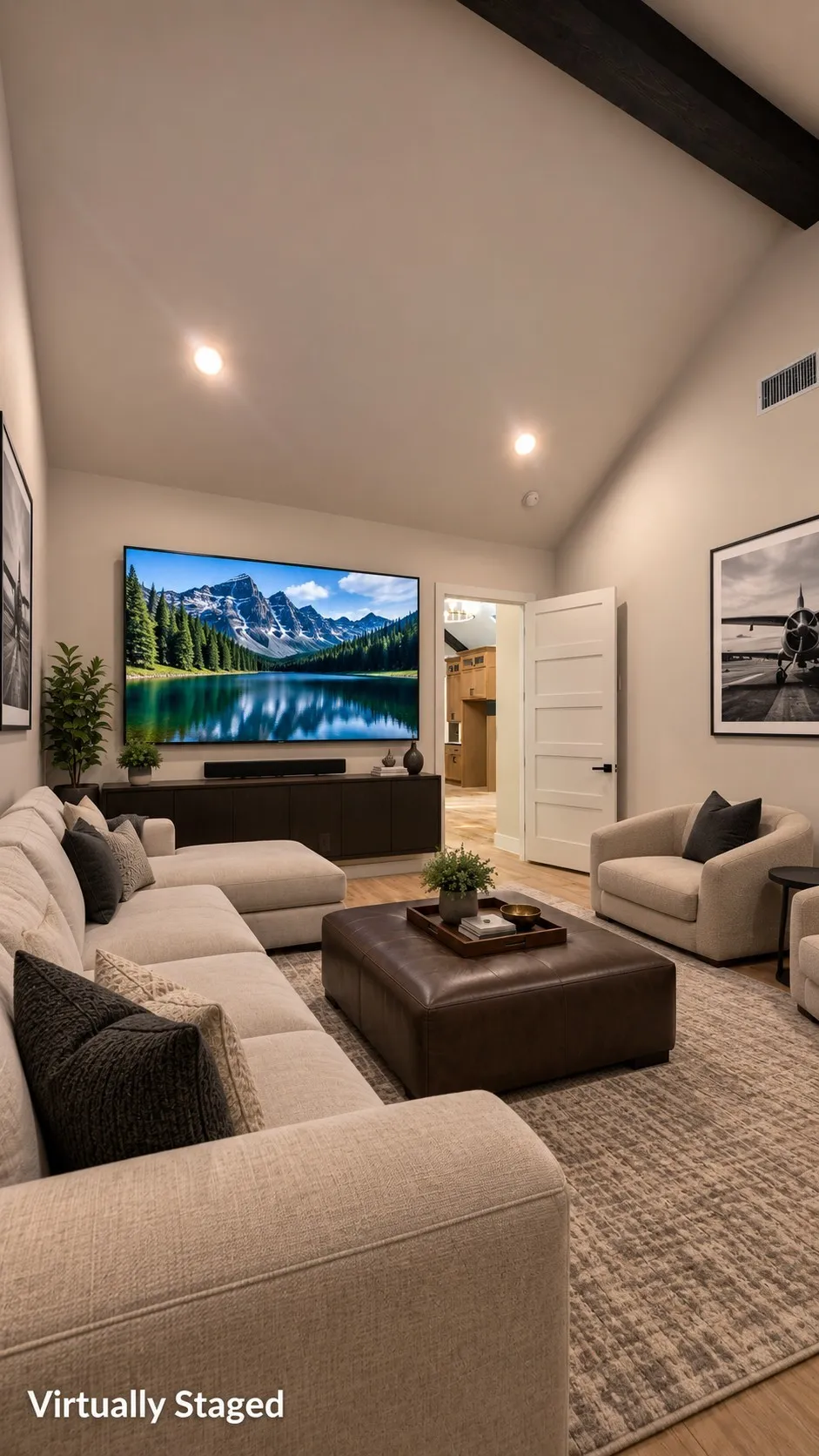 Vaulted ceiling with exposed beam, recessed lighting, wood-finish flooring, white paneled interior door, and built-in media console