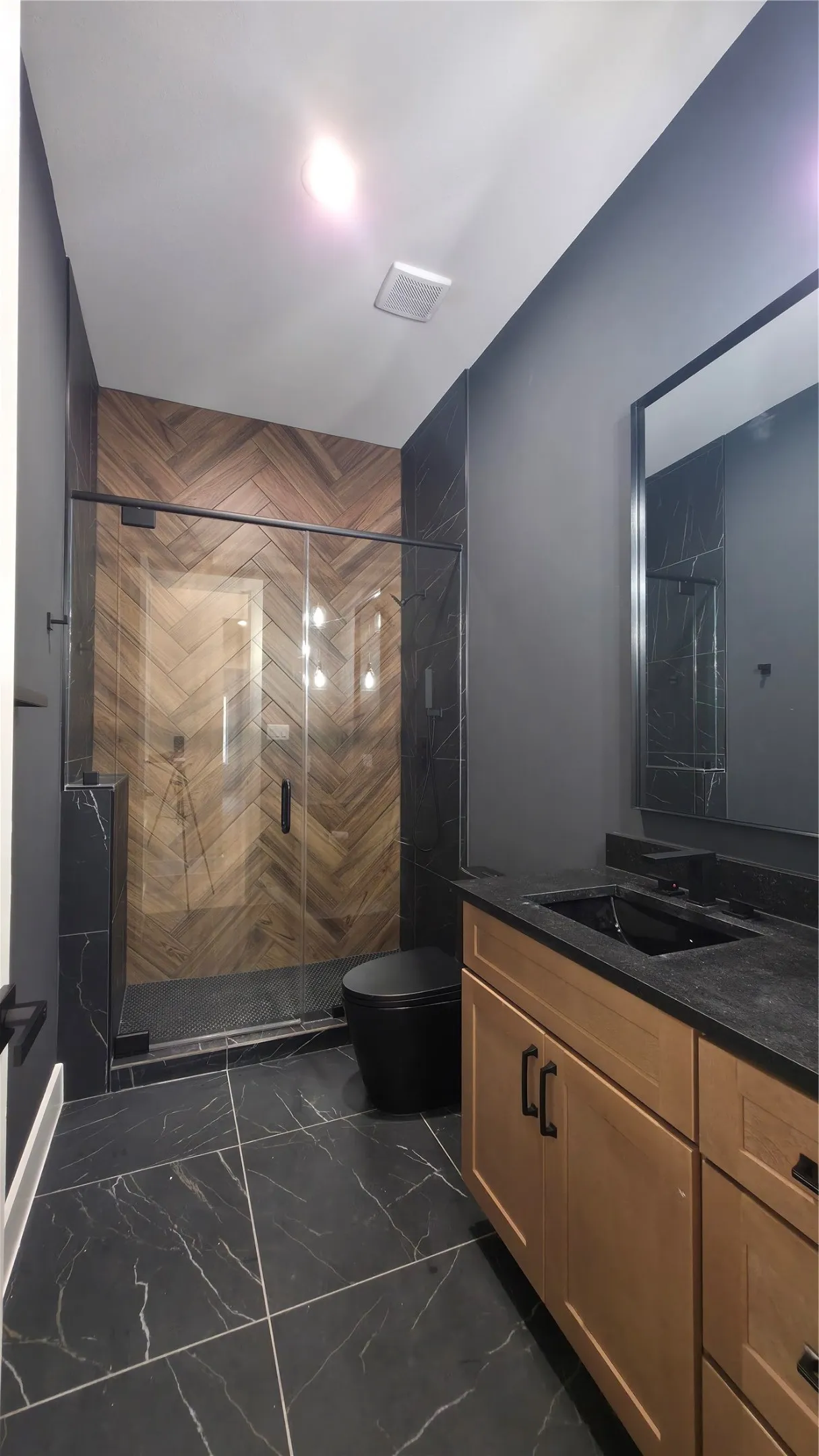 Black large-format tile flooring with white veining