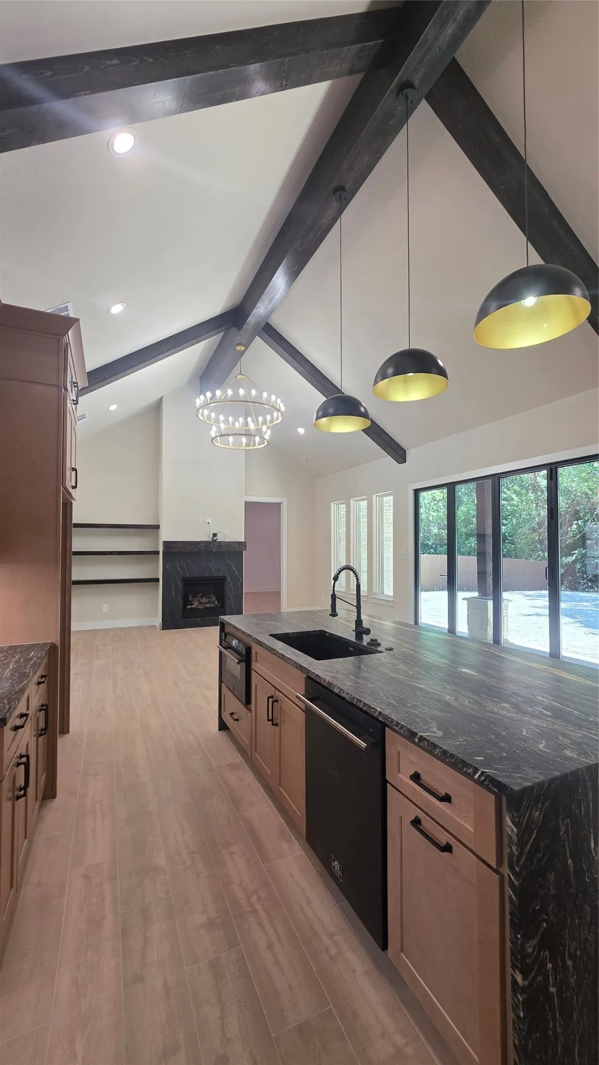 Vaulted ceiling with exposed beams and recessed lighting