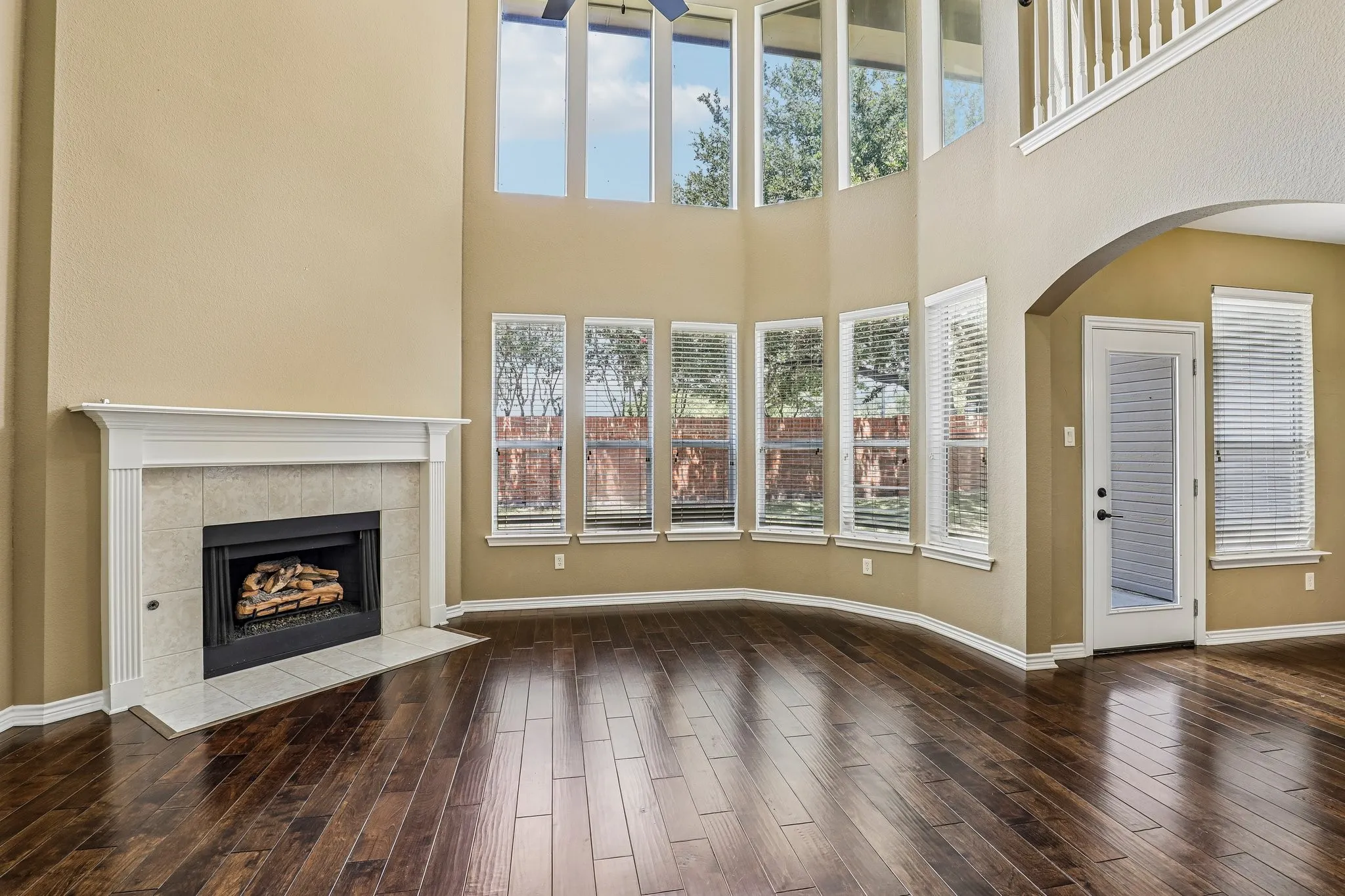 Grand living room anchored by a cozy fireplace.